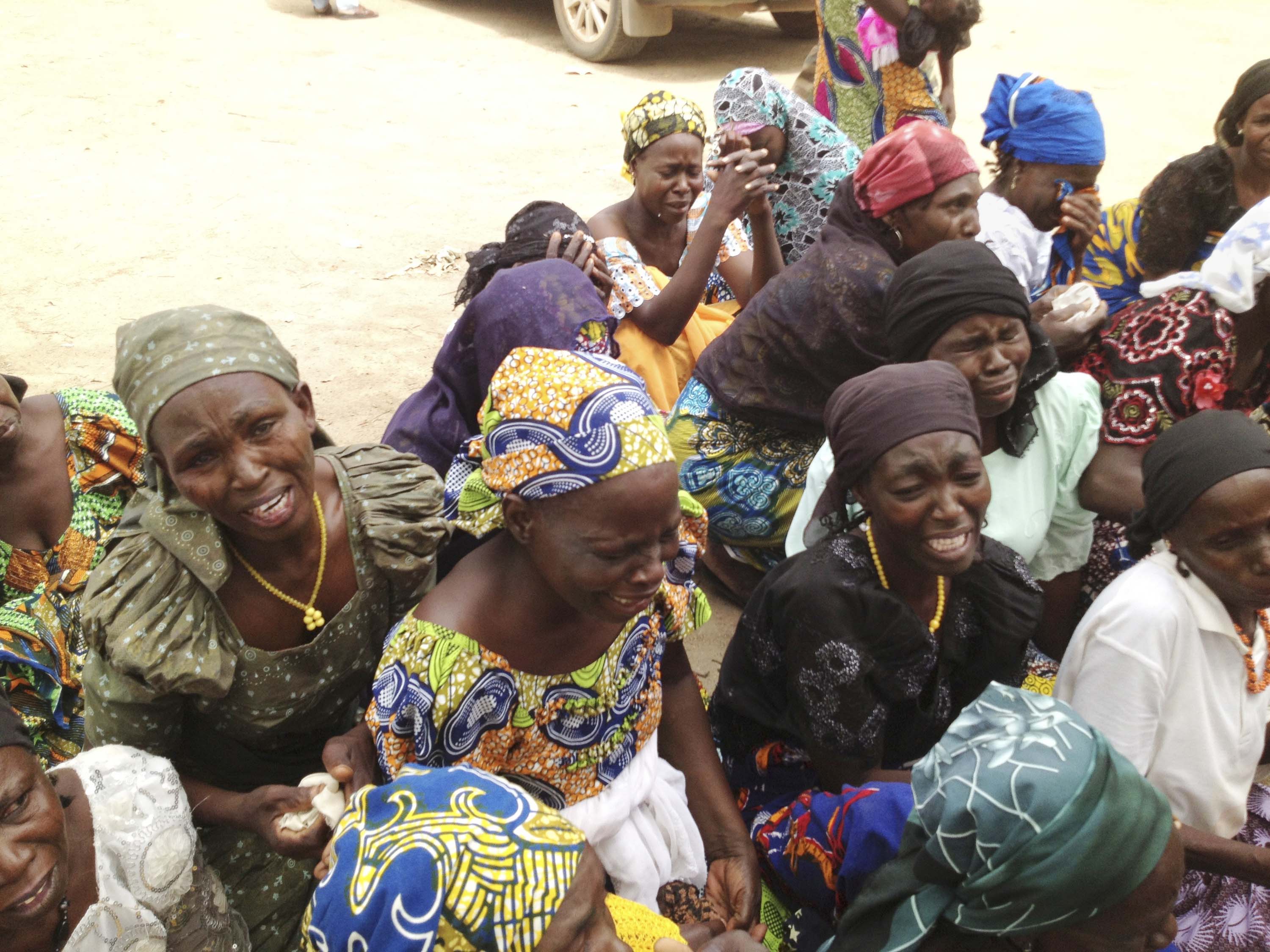 Mothers of kidnapped girls weep on the grounds of the burned-out ruins of Chibok Government Girls Secondary School in Chibok, Nigeria.