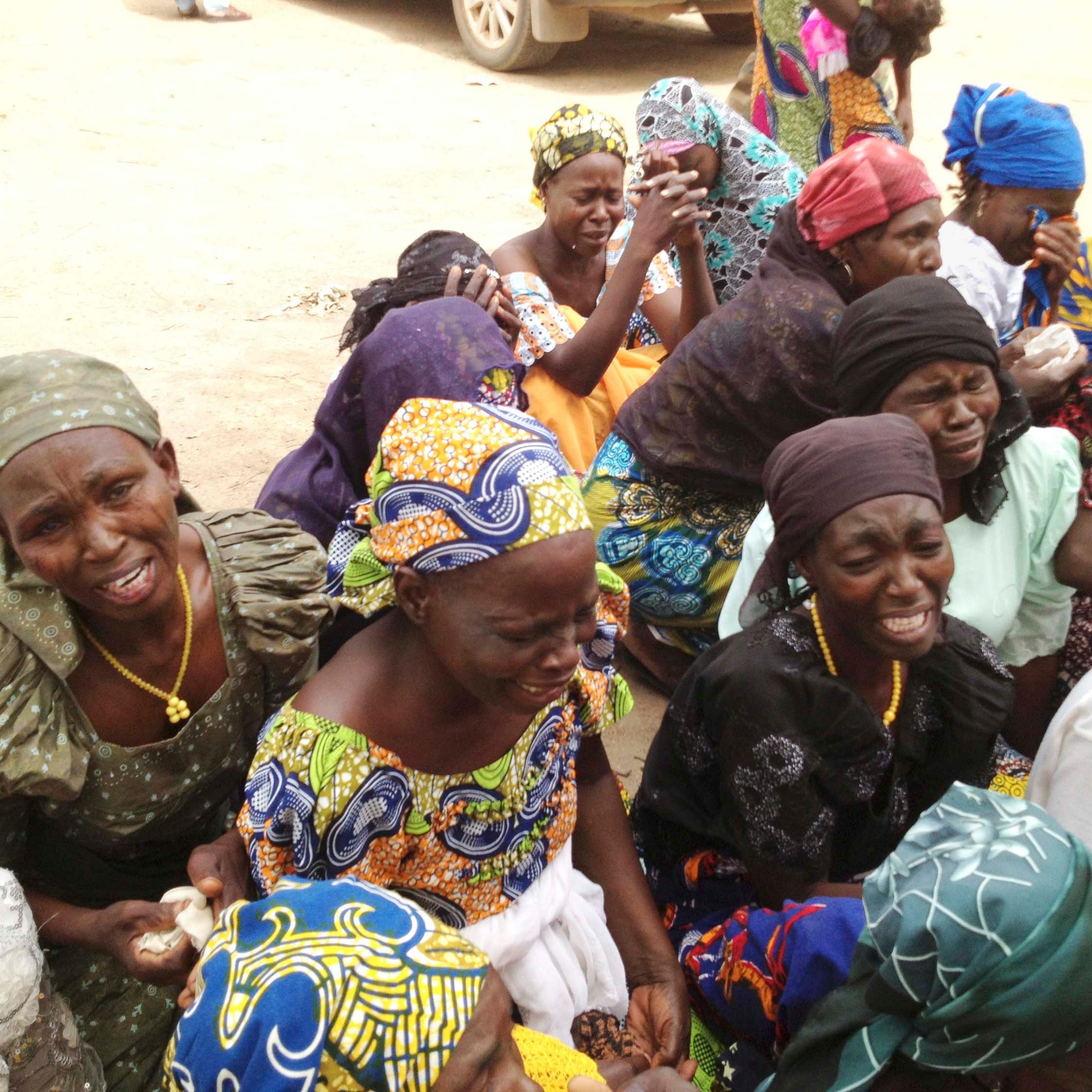 Mothers of kidnapped girls weep on the grounds of the burned-out ruins of Chibok Government Girls Secondary School in Chibok, Nigeria.