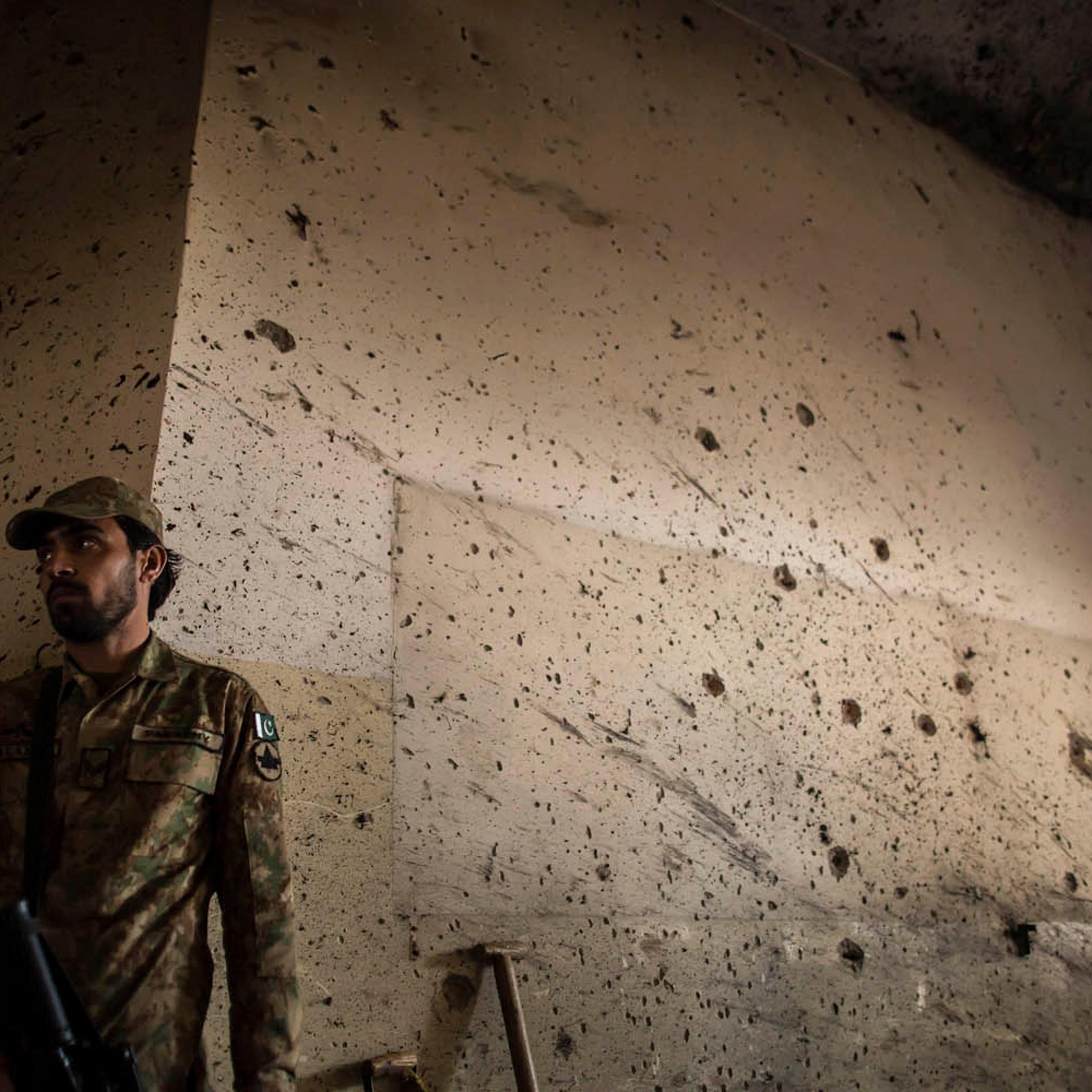An army soldier stands guard inside the Army Public School, which was attacked by Taliban gunmen, in Peshawar