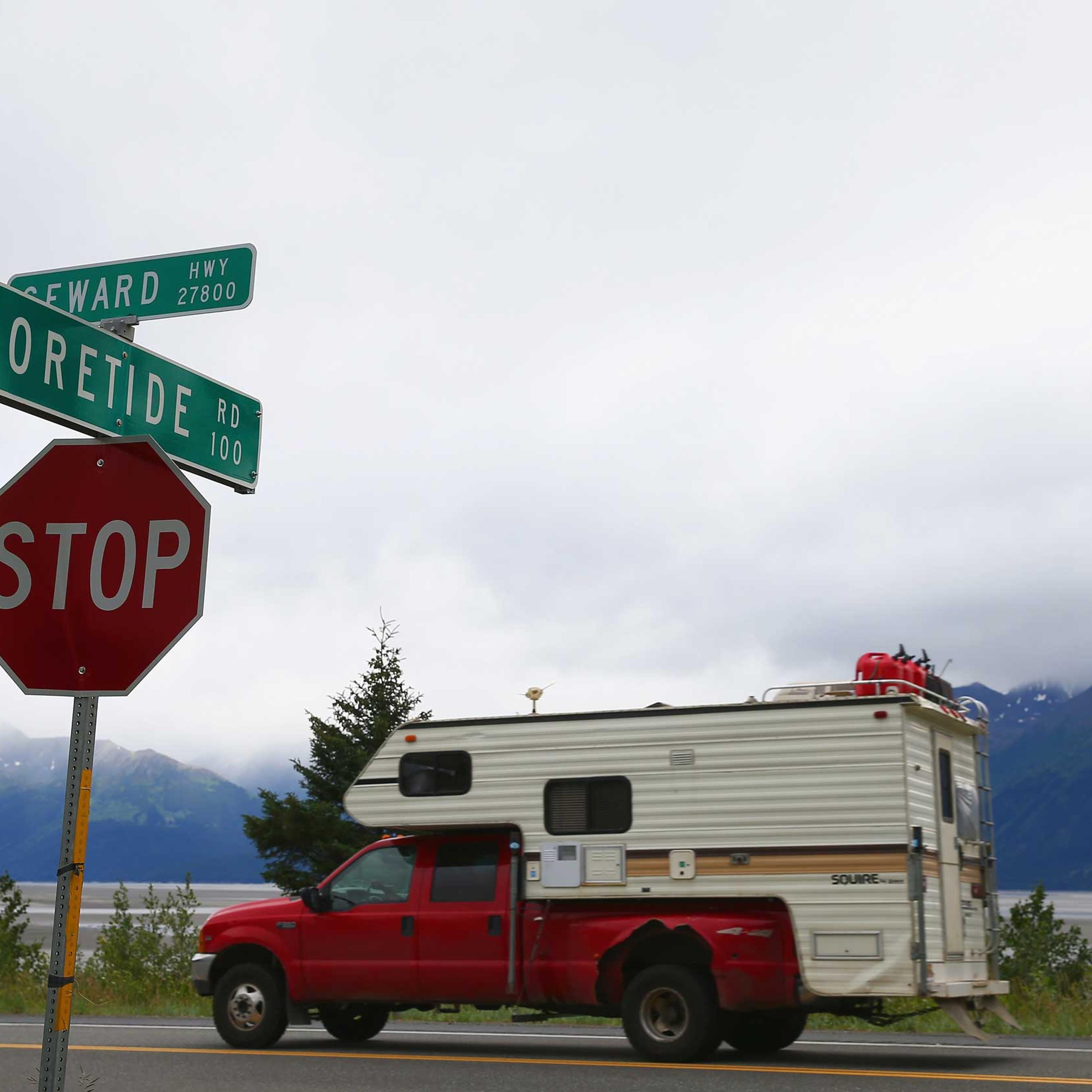 A truck passes a street sign named for the Bore Tide at Turnagain Arm in Anchorage, Alaska, in 2014.