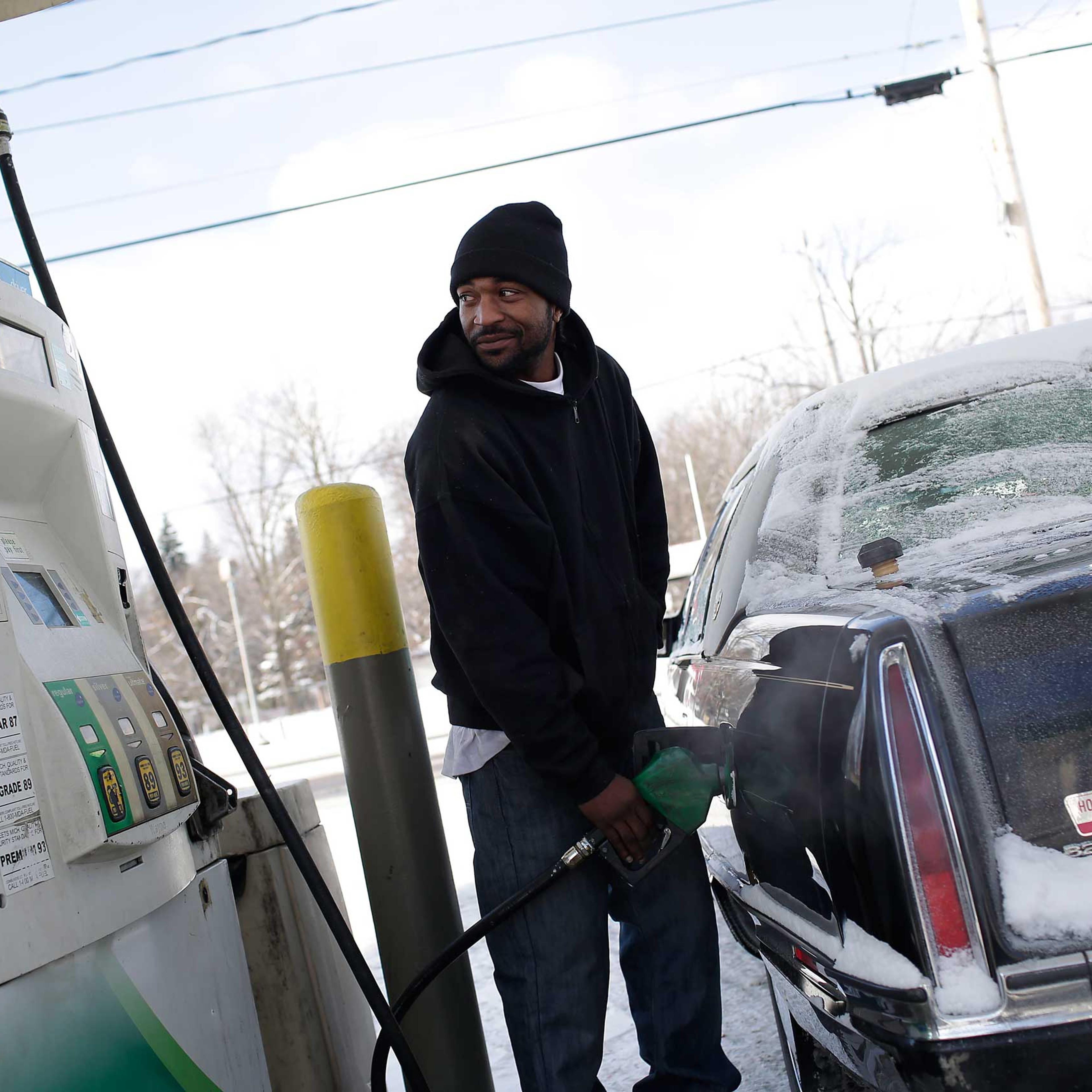 A motorist pumps fuel into his vehicle at a BP station Jan. 6, 2015 in Flint, Michigan.