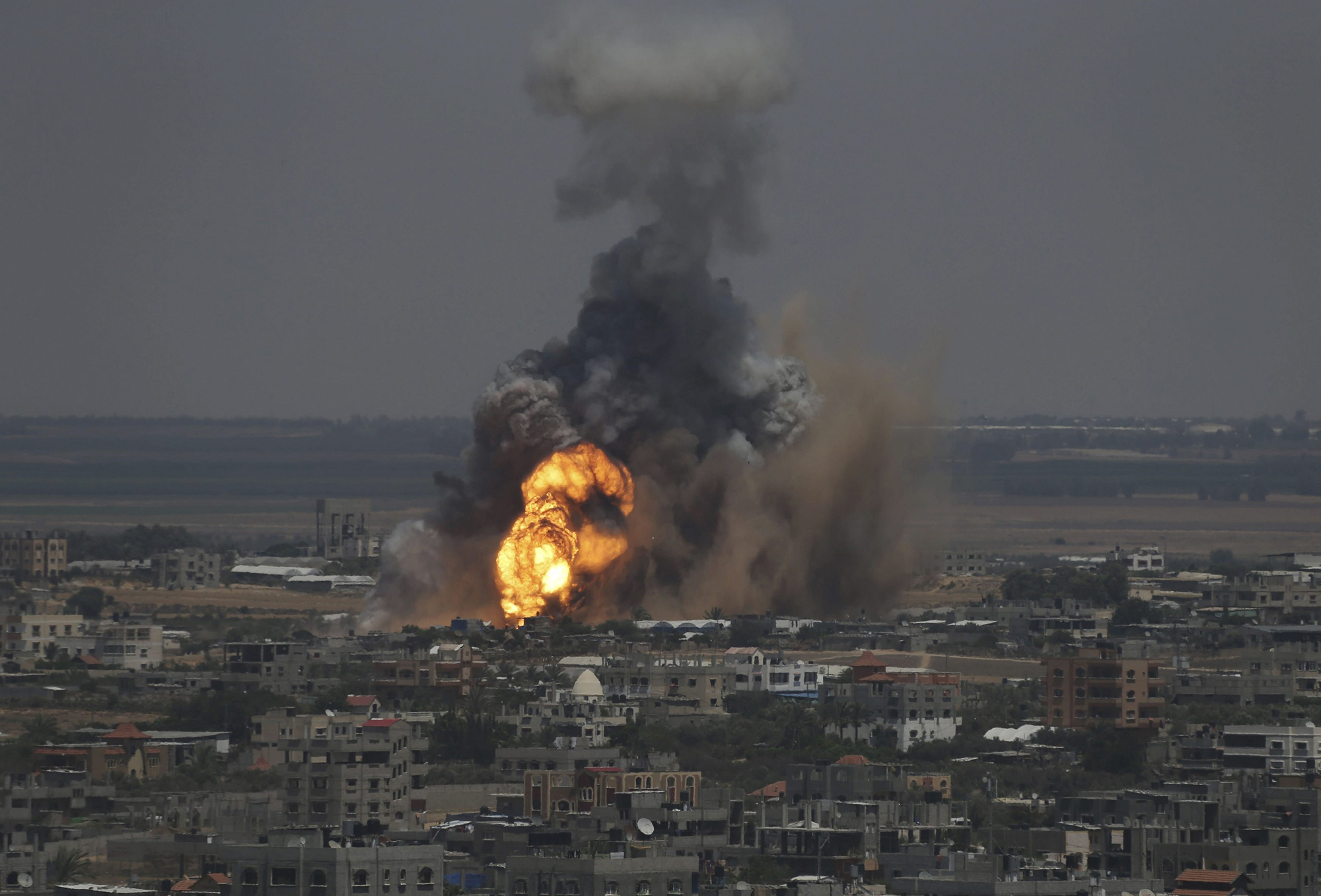 Smoke and flames are seen following what police said was an Israeli air strike in Rafah in the southern Gaza Strip July 8, 2014.