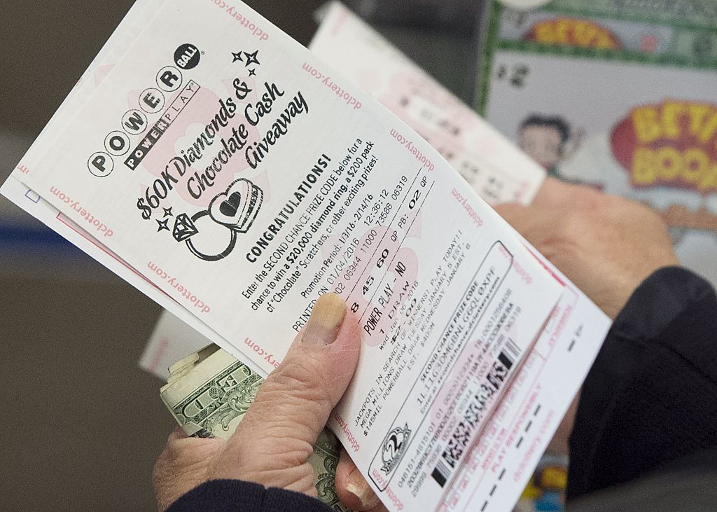 A woman purchases a Powerball lottery ticket at a liquor store in Washington, DC, on Jan. 4, 2016.