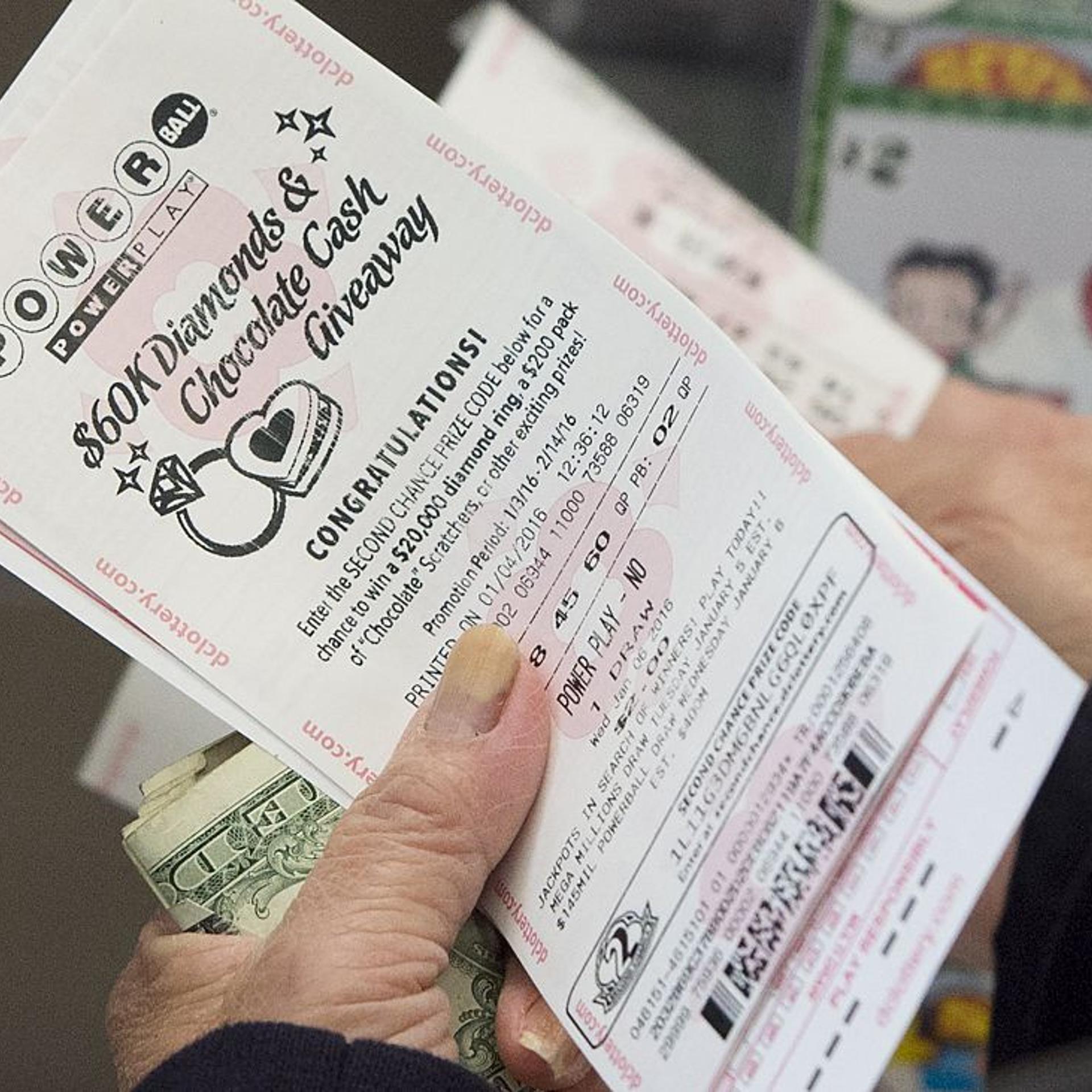 A woman purchases a Powerball lottery ticket at a liquor store in Washington, DC, on Jan. 4, 2016.