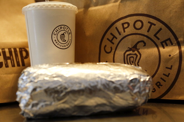 A steak burrito is arranged for a photograph with a drink and bags of chips at a Chipotle Mexican Grill Inc. restaurant in Hollywood, California, U.S., on Tuesday, July 16, 2013.