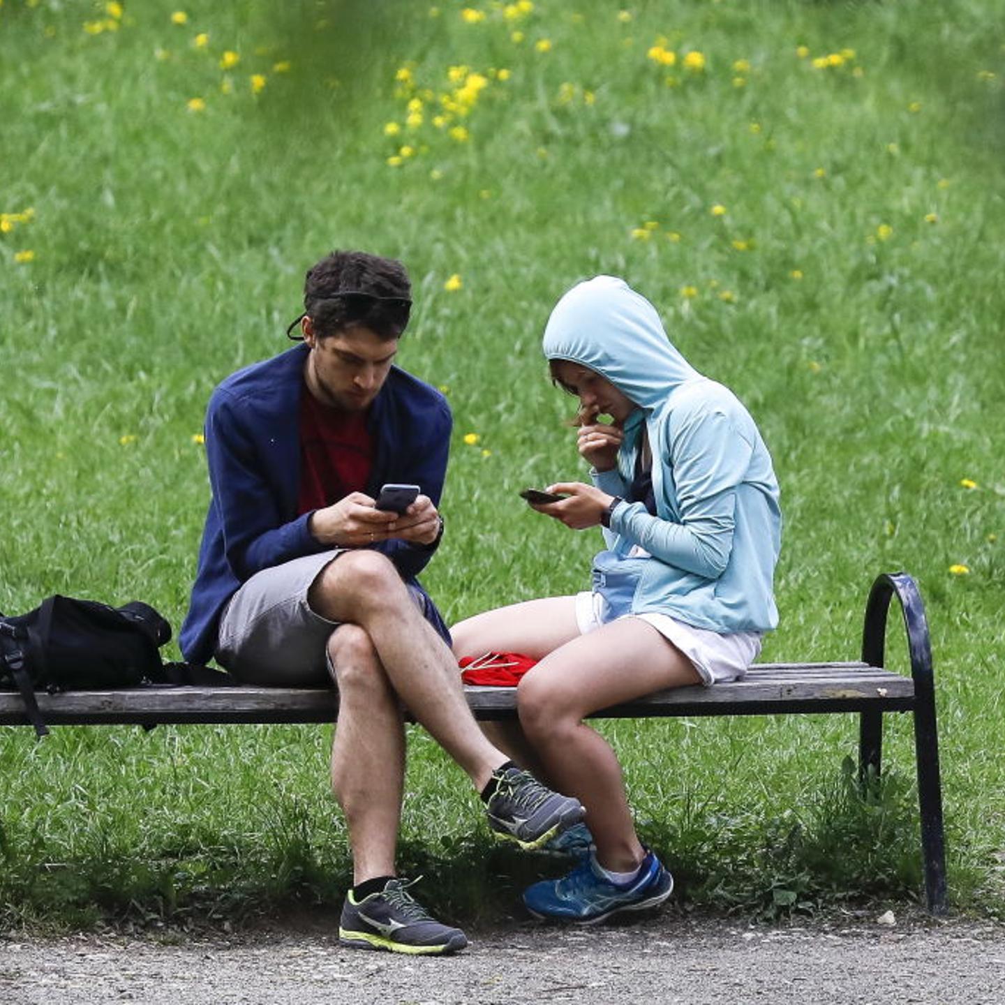 Couple on smartphones ignoring each other.