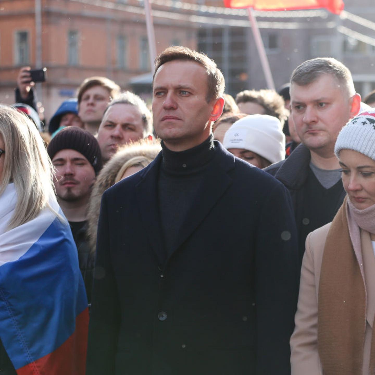 Navalny, center, and his wife Yulia, right, walk with demonstrators during a rally in Moscow in February 2019.
