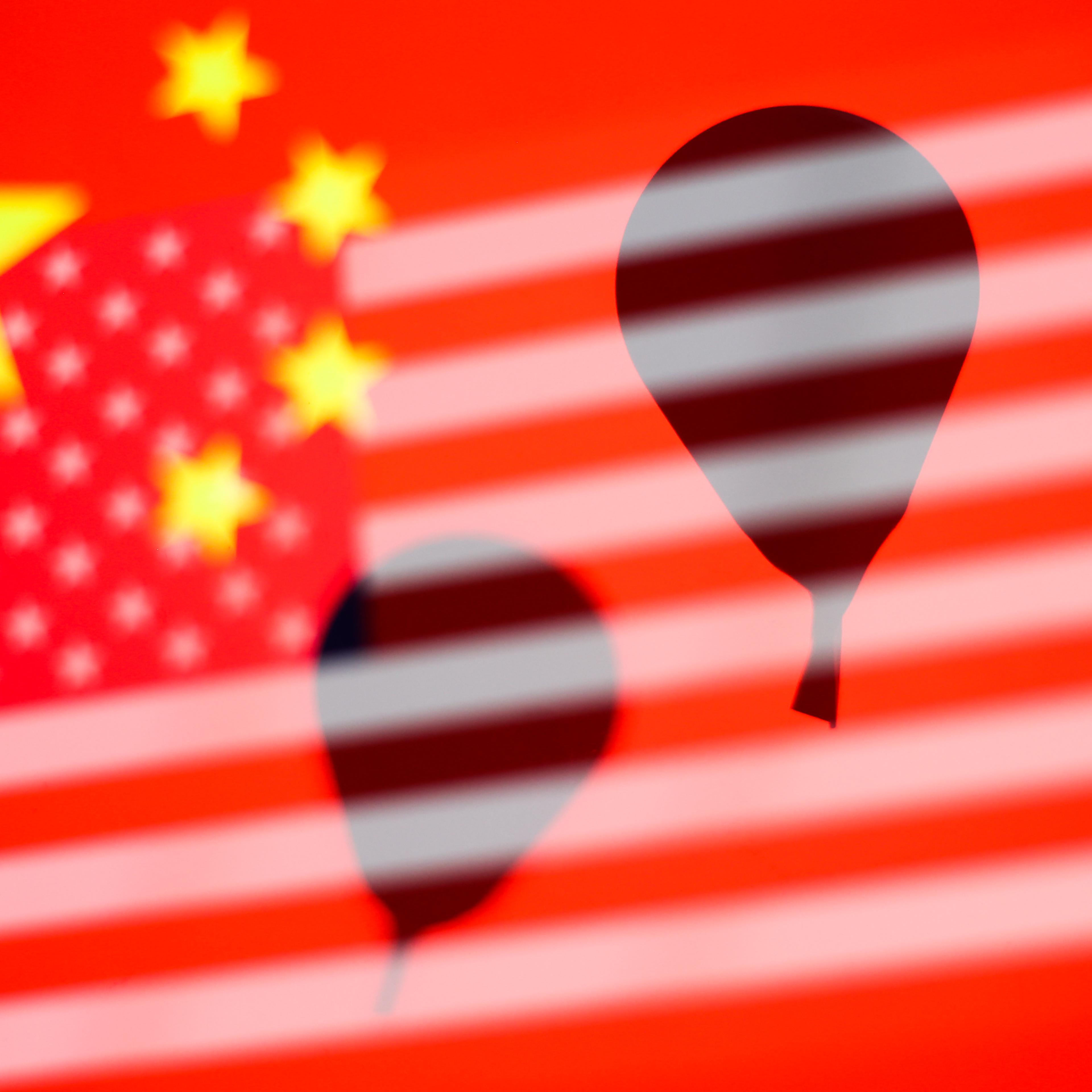 Balloon silhouettes are seen with Chinese and Americans flags in this multiple exposure illustration photo taken in Krakow, Poland, on Feb. 14, 2023.