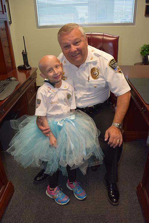 Sydney Coari poses with St. Charles County Police Chief David Todd