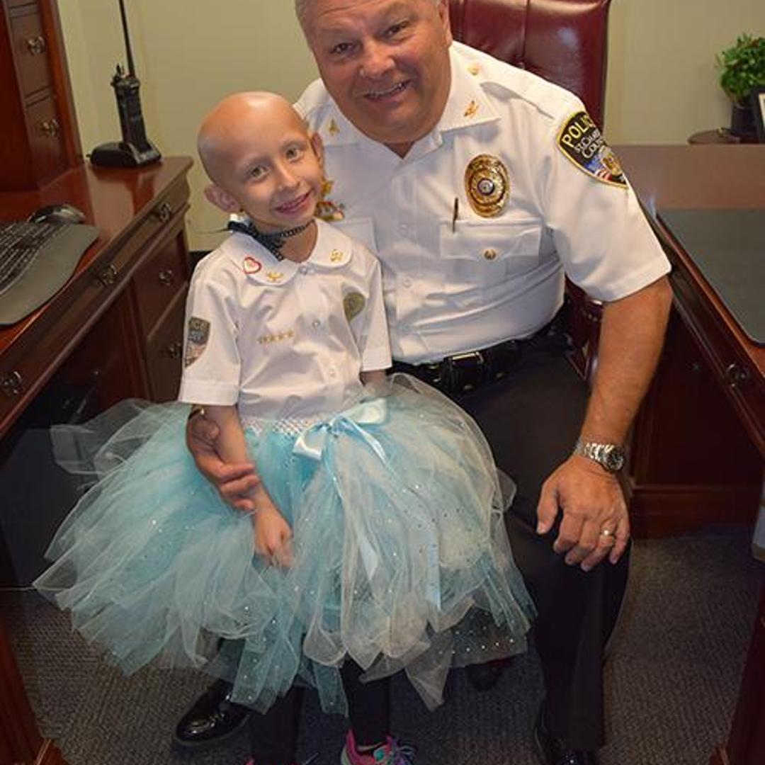 Sydney Coari poses with St. Charles County Police Chief David Todd
