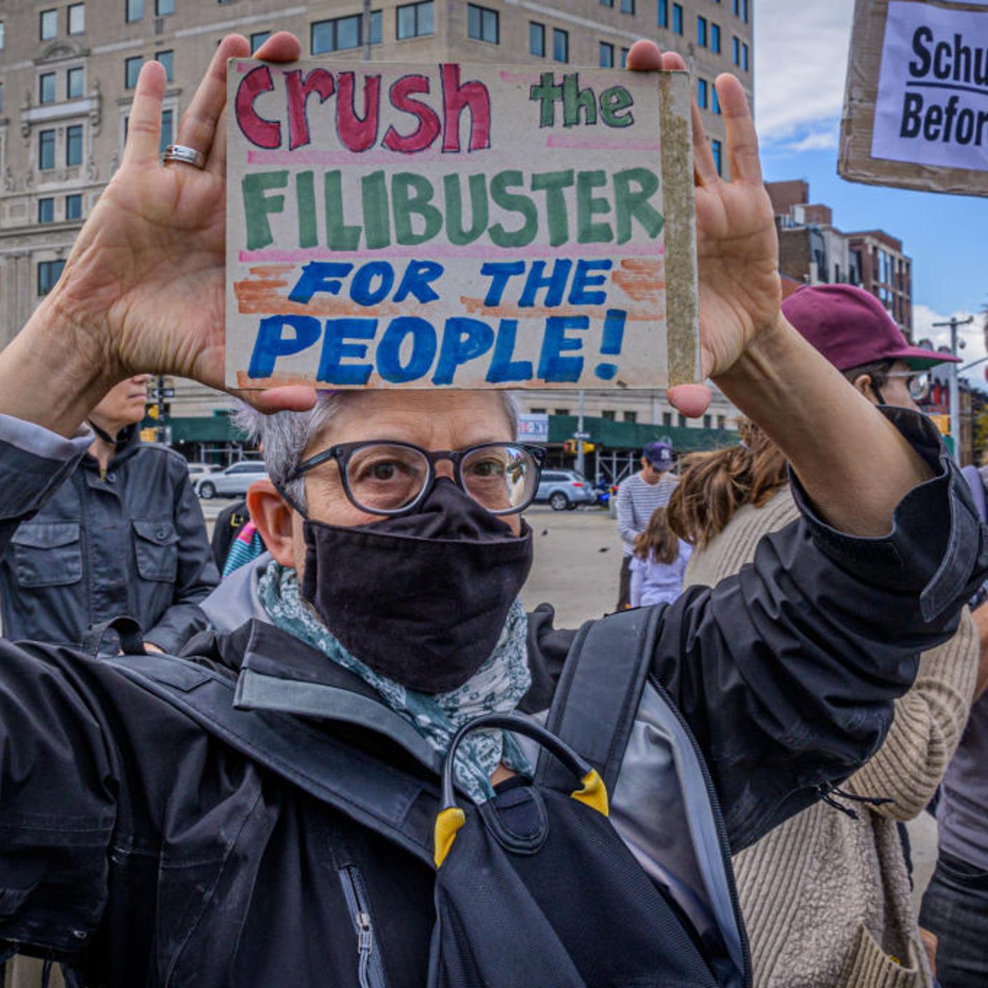 Participant seen holding a sign at the protest. Fair