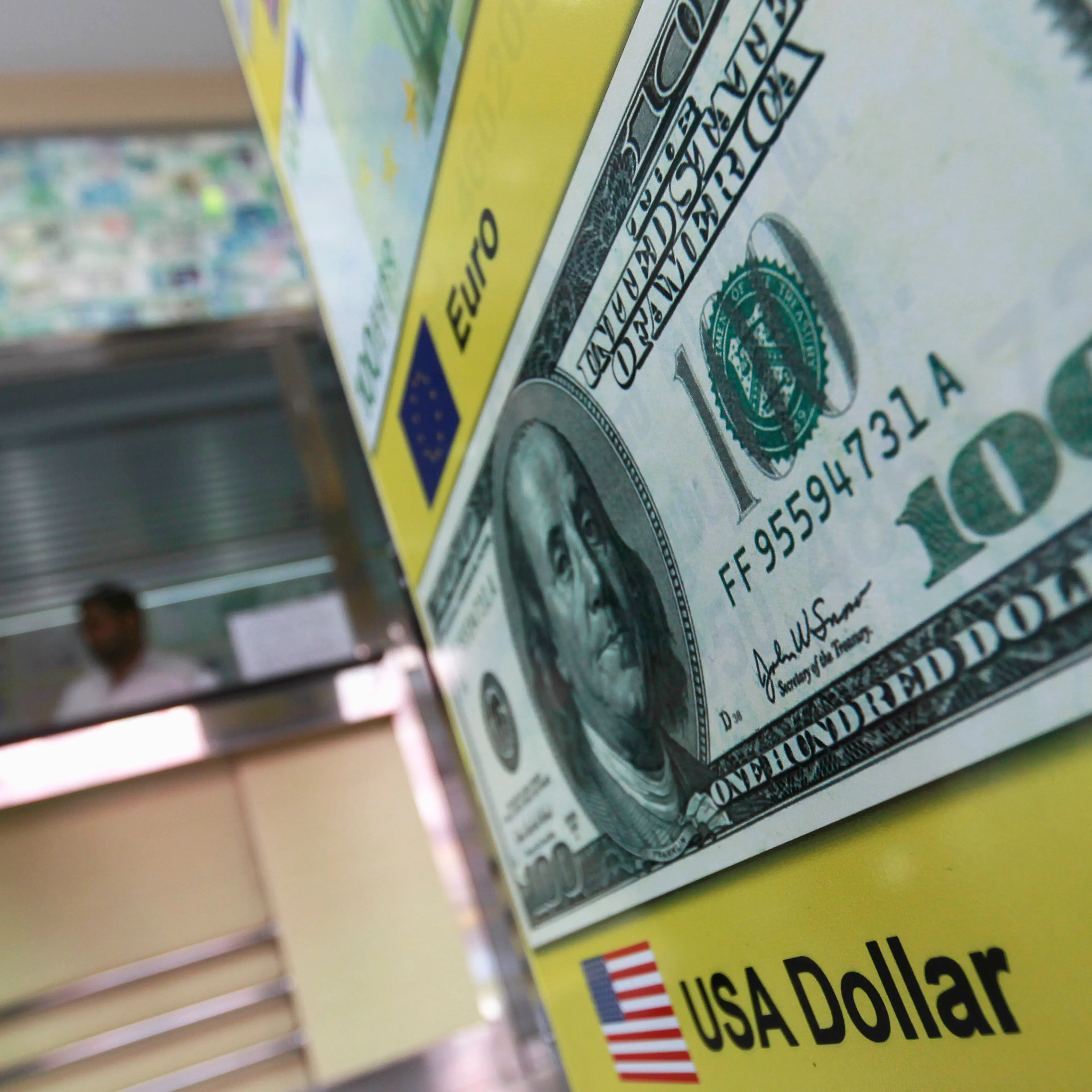 A man stands next to a money changer in Colombo