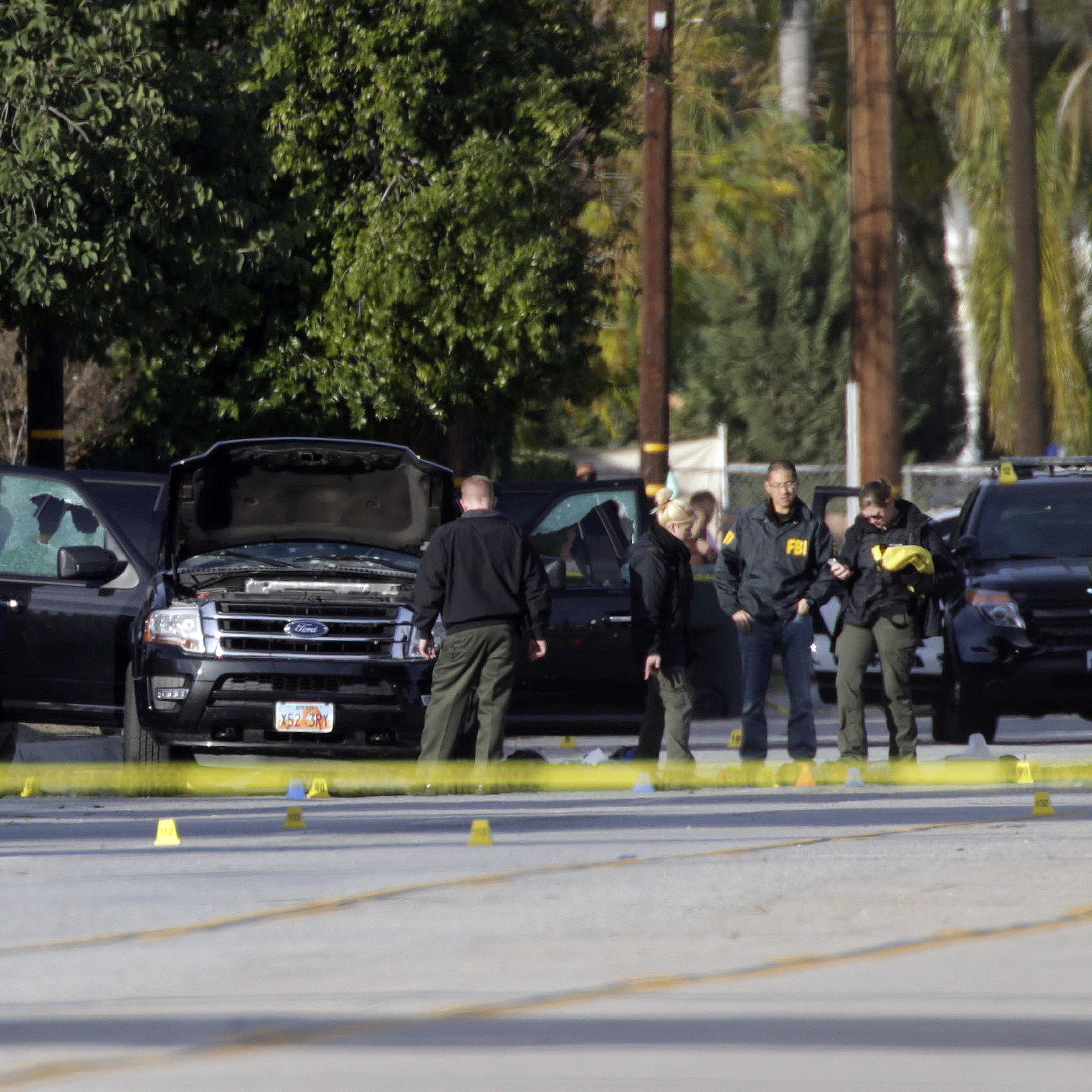 Law enforcement personnel continue to investigate on San Bernardino Avenue, where two suspects in the mass shooting at the Inland Regional Center died in a shootout with police in San Bernardino, Calif. on Dec. 3, 2015.