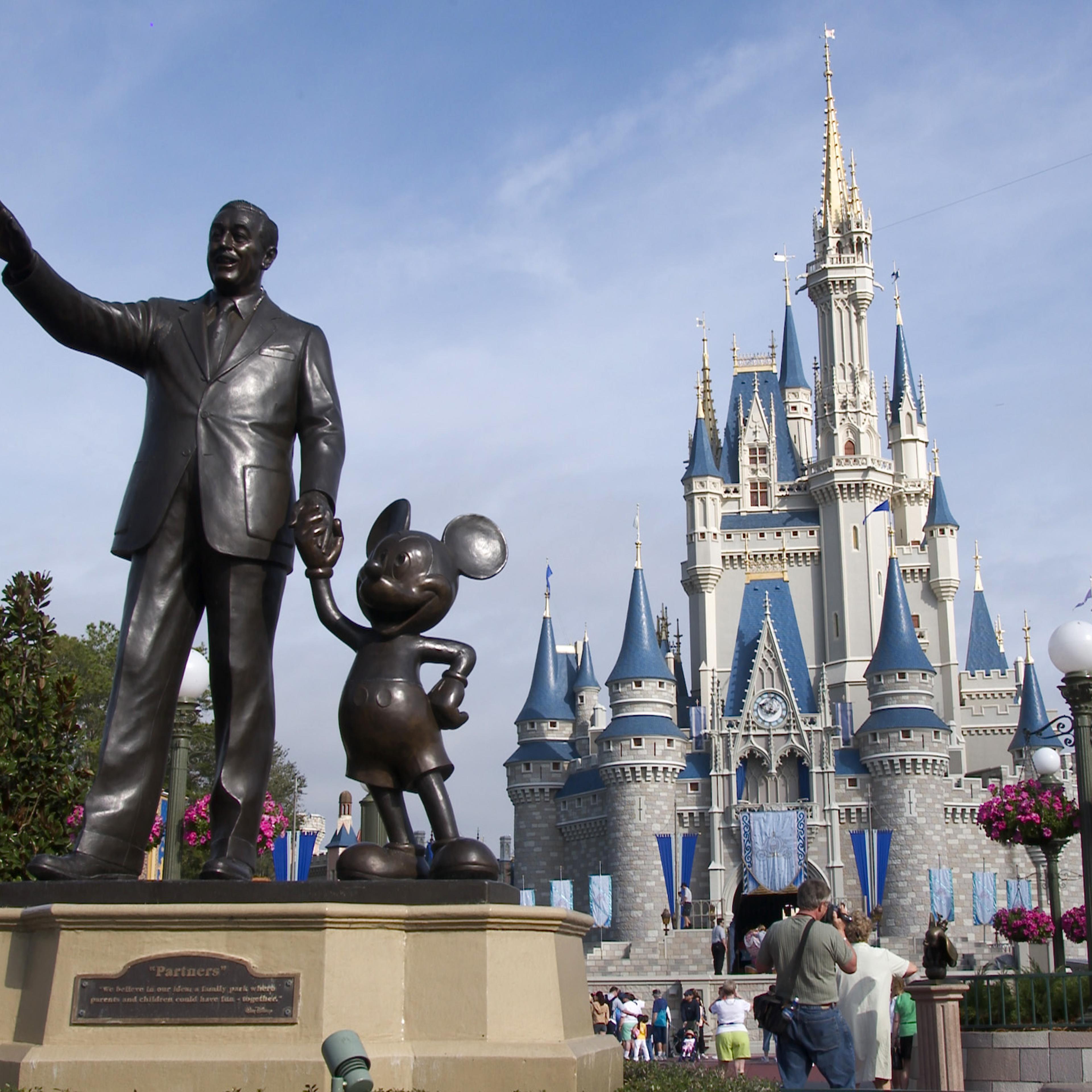 A statue of Walt Disney and Mickey Mouse stands in front of