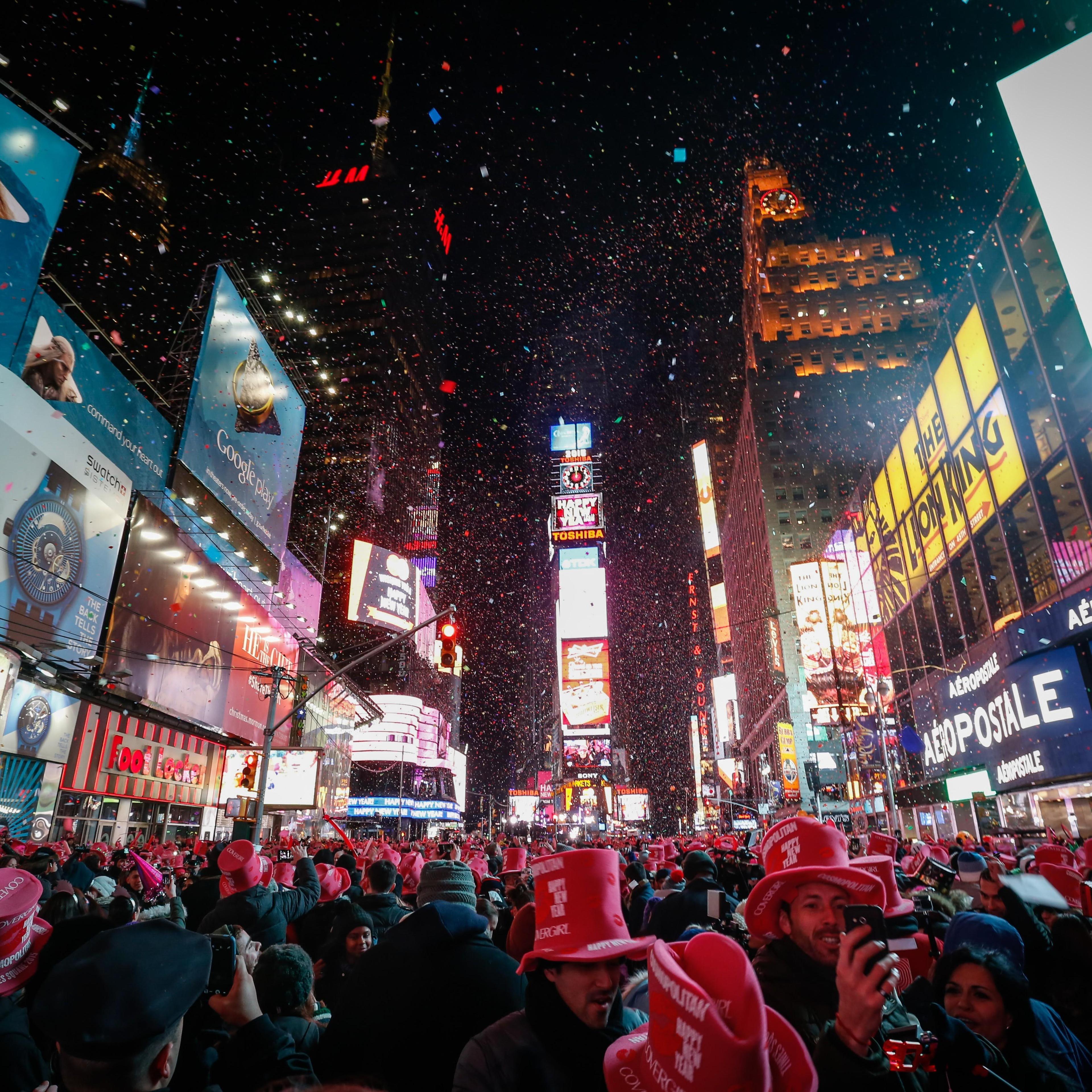 NEW YORK, NY - JANUARY 01: Young revelers cheer on New Year's Eve in New York's Times Square, United States on January 01, 2015. An estimated one million people assembled on New York's Times Square to count down to the New Year. Crowd gathered to watch t