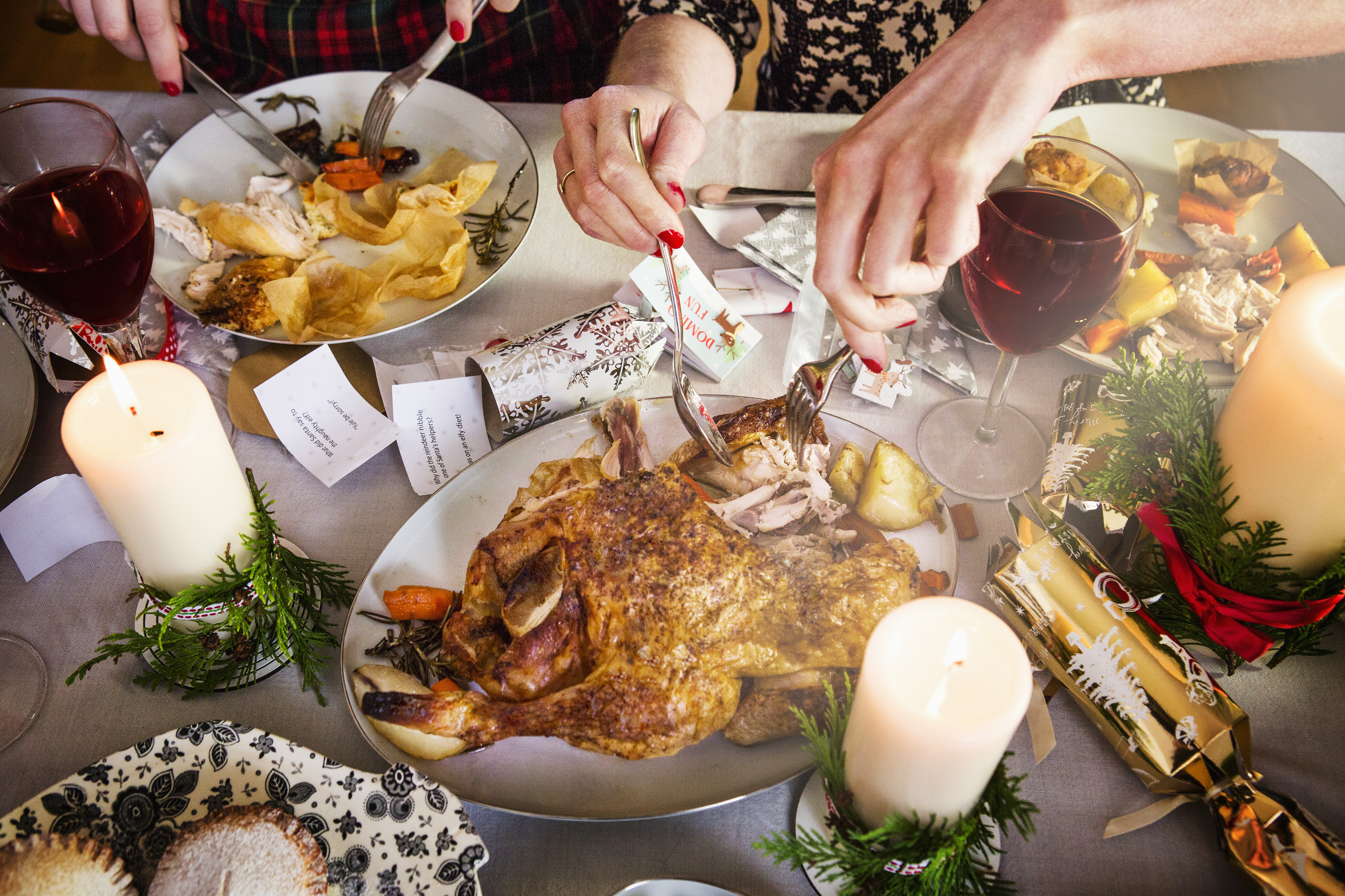 Close up of hands taking turkey and cutting food.
