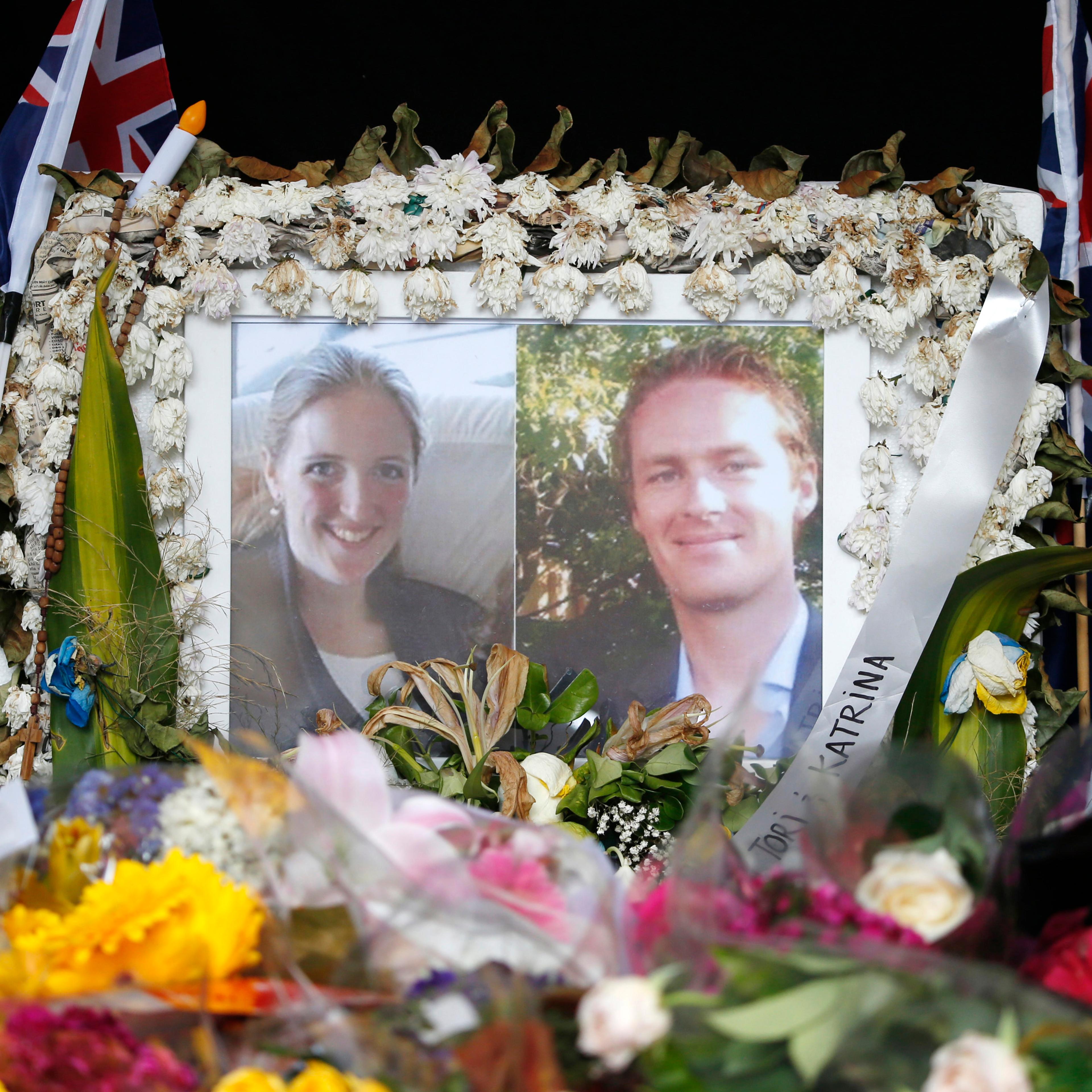 Photographs of Sydney's cafe siege victims, lawyer Katrina Dawson and cafe manager Tori Johnson are displayed in a floral tribute near the site of the siege in Sydney's Martin Place