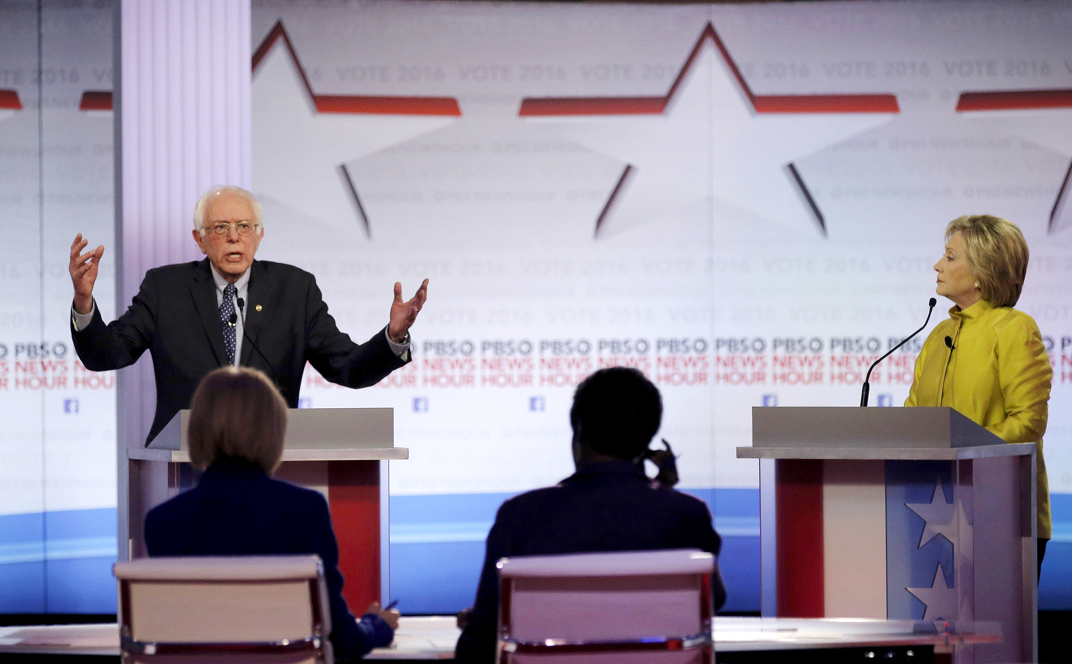 Democratic U.S. presidential candidate Senator Bernie Sanders speaks as former Secretary of State Hillary Clinton listens at the PBS NewsHour Democratic presidential candidates debate in Milwaukee