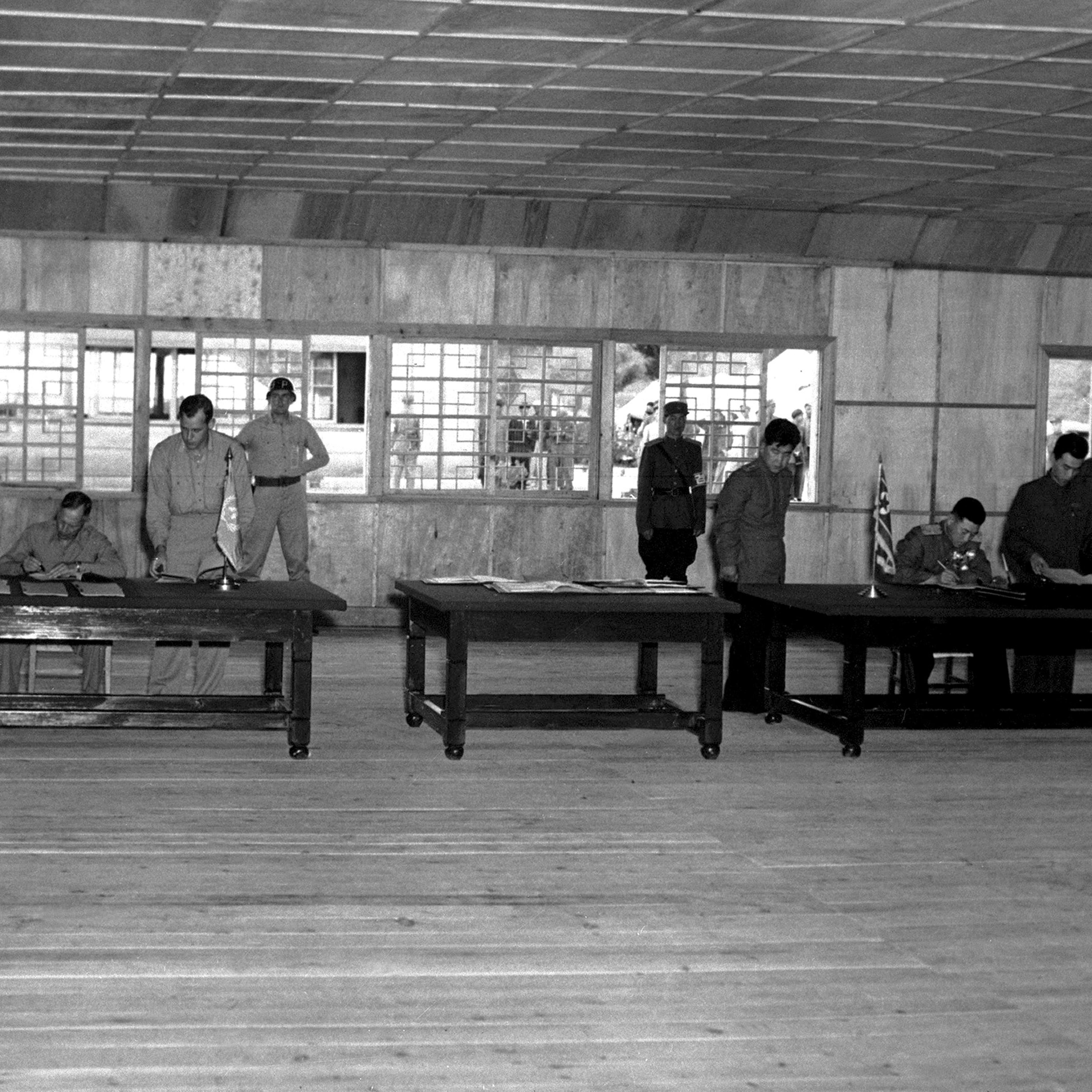 General W. K. Harrison, Jr., left, and North Korean General Nam Il, right, signs the armistice ending the three year Korean conflict, Panmunjom, Korea, July 1953.