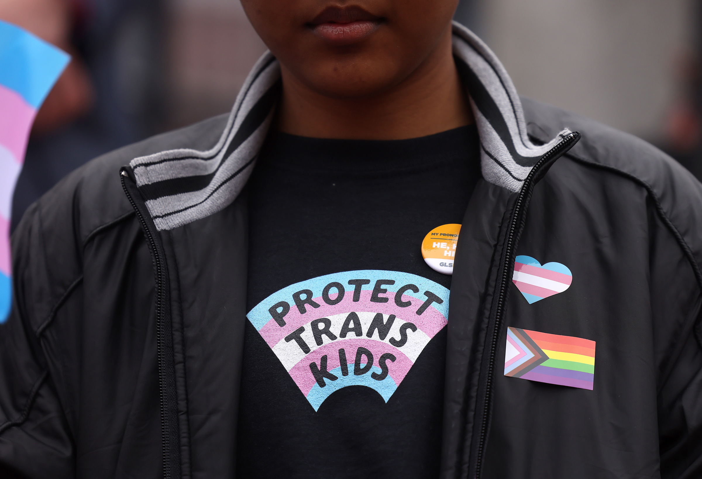 A person takes part in a rally during a Transgender Day of Visibility Event named, We Are A State of Love: A Gathering of Visible Solidarity With LGBTQ Youth outside of the State House in Boston