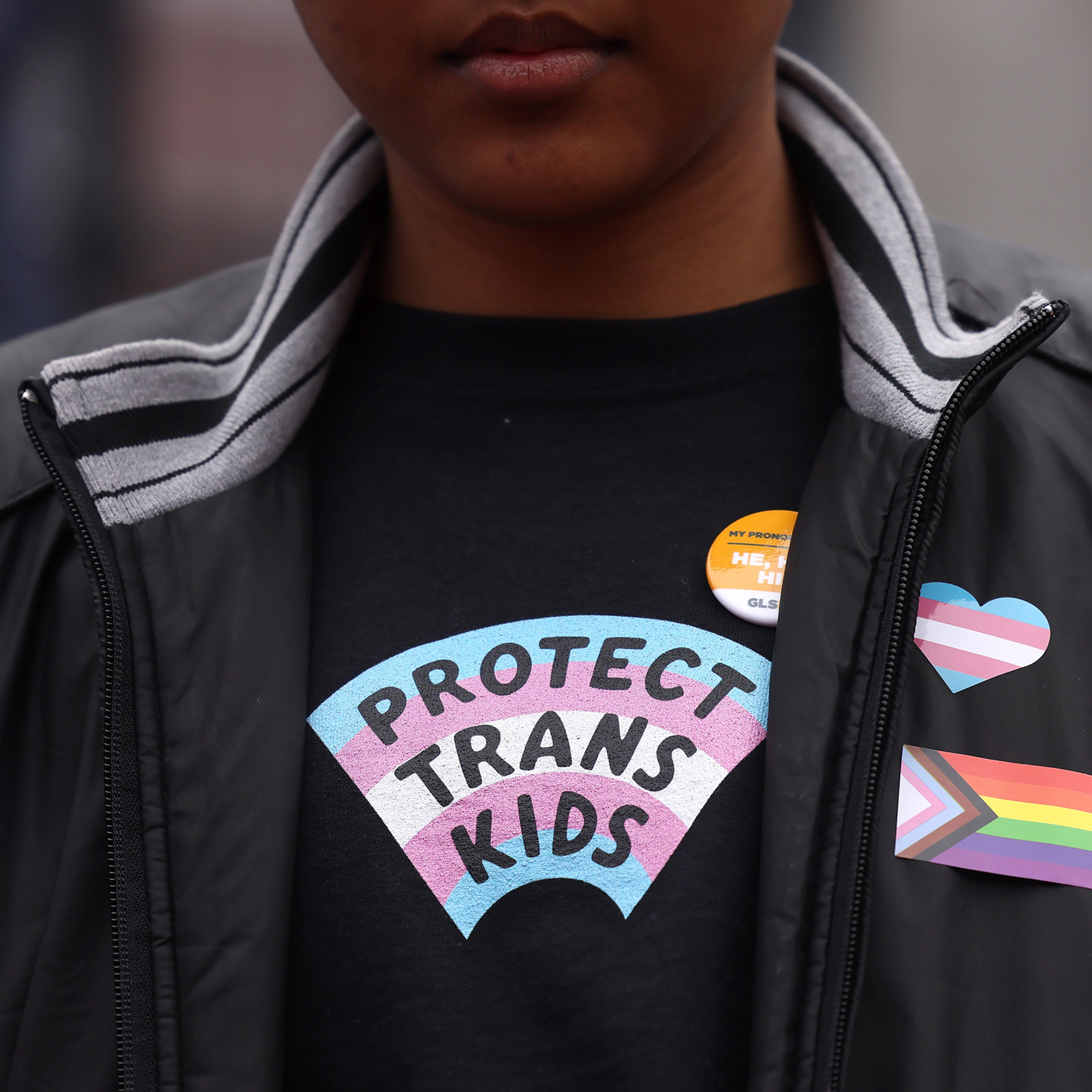A person takes part in a rally during a Transgender Day of Visibility Event named, We Are A State of Love: A Gathering of Visible Solidarity With LGBTQ Youth outside of the State House in Boston
