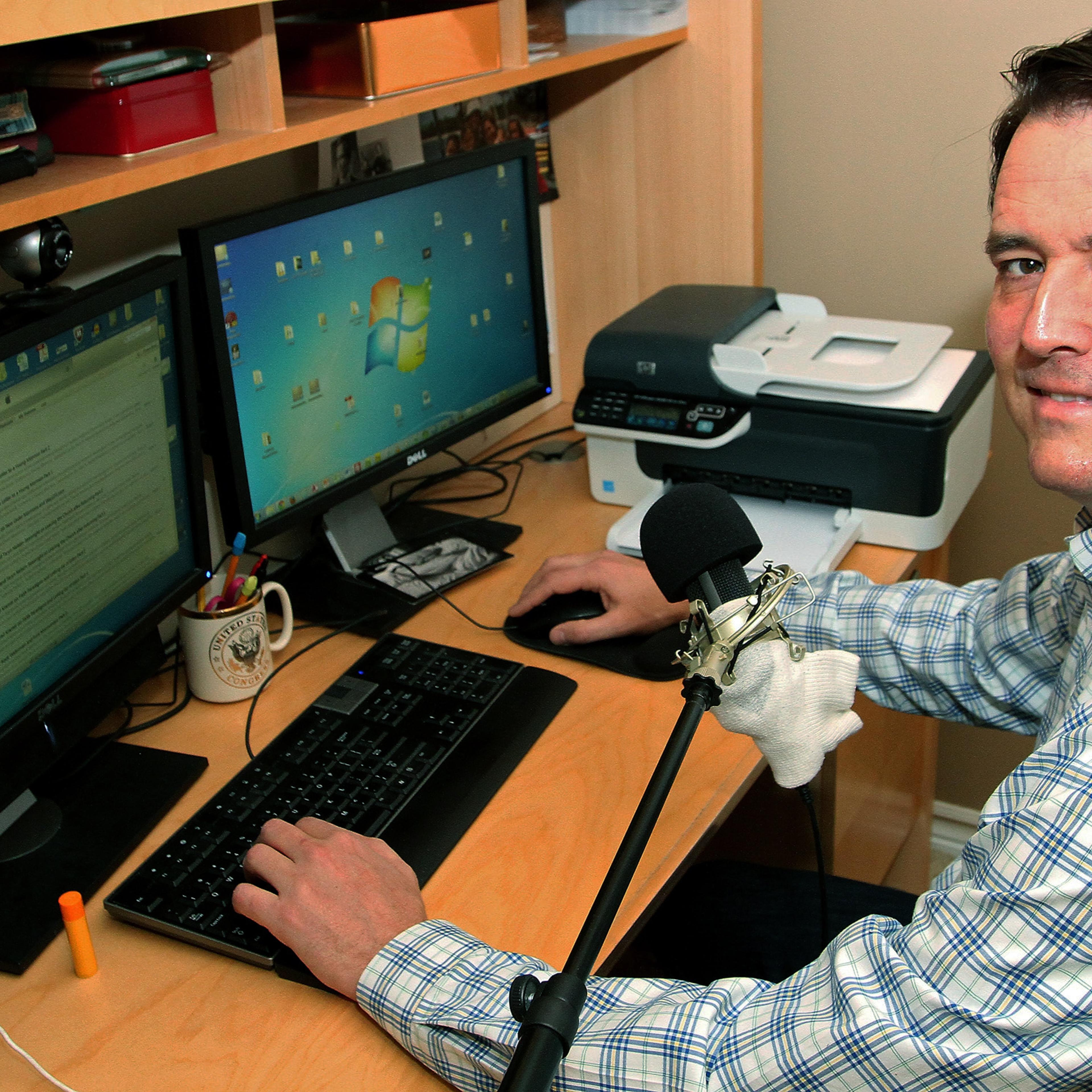John Dehlin sits in his basement studio where he broadcasts his podcast at his home in North Logan, Utah on May 16, 2014.