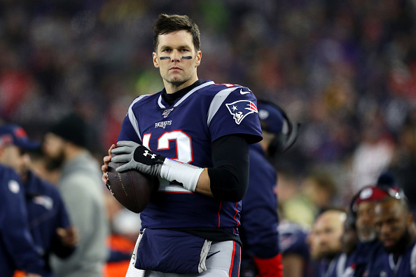 Tom Brady of the New England Patriots looks on from the sideline during the the AFC Wild Card Playoff game against the Tennessee Titans at Gillette Stadium in Foxborough, Mass., on Jan. 04, 2020.