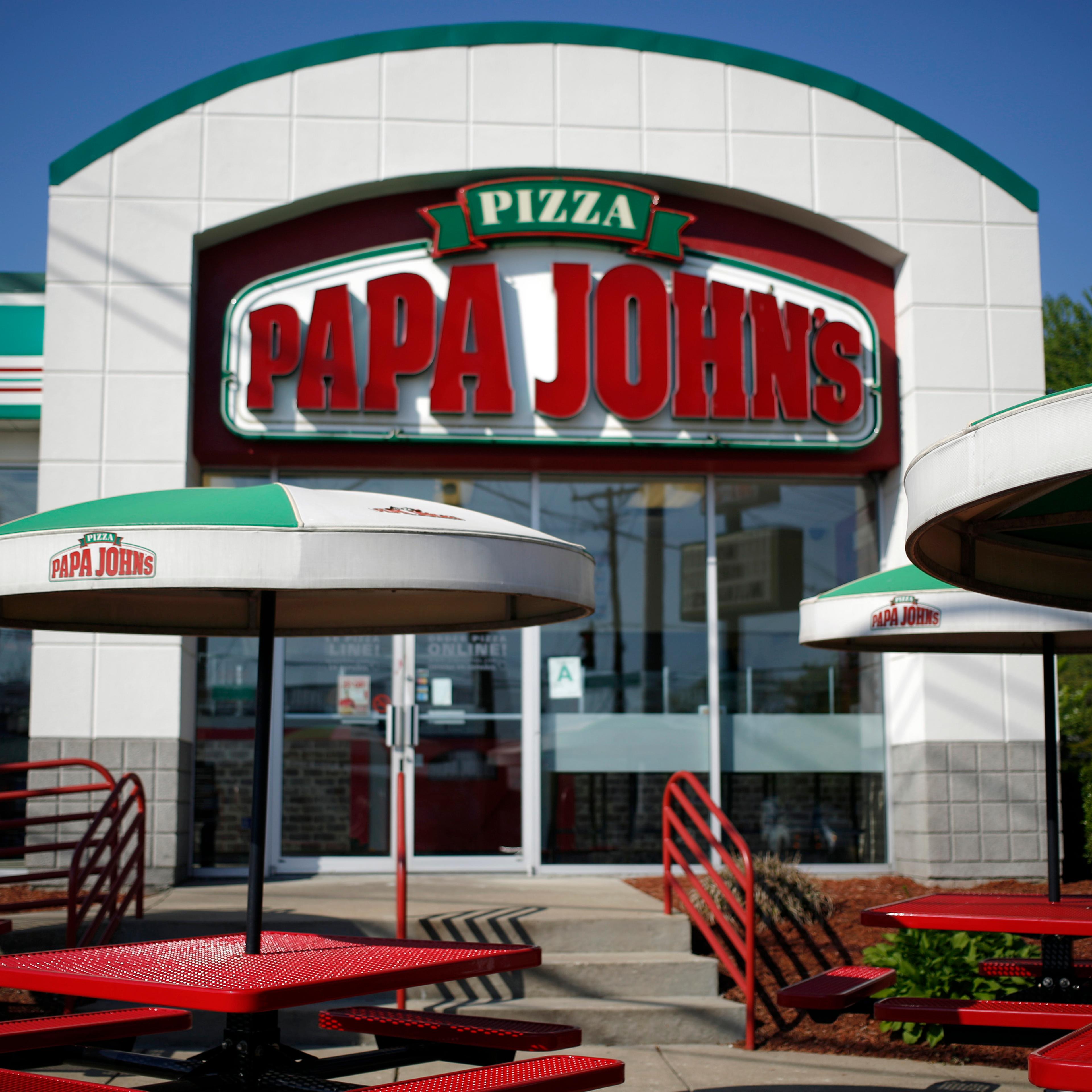 Umbrellas and outdoor seating stand outside a Papa John's International Inc. restaurant in Louisville, Kentucky, U.S., on Friday, May 1, 2015.