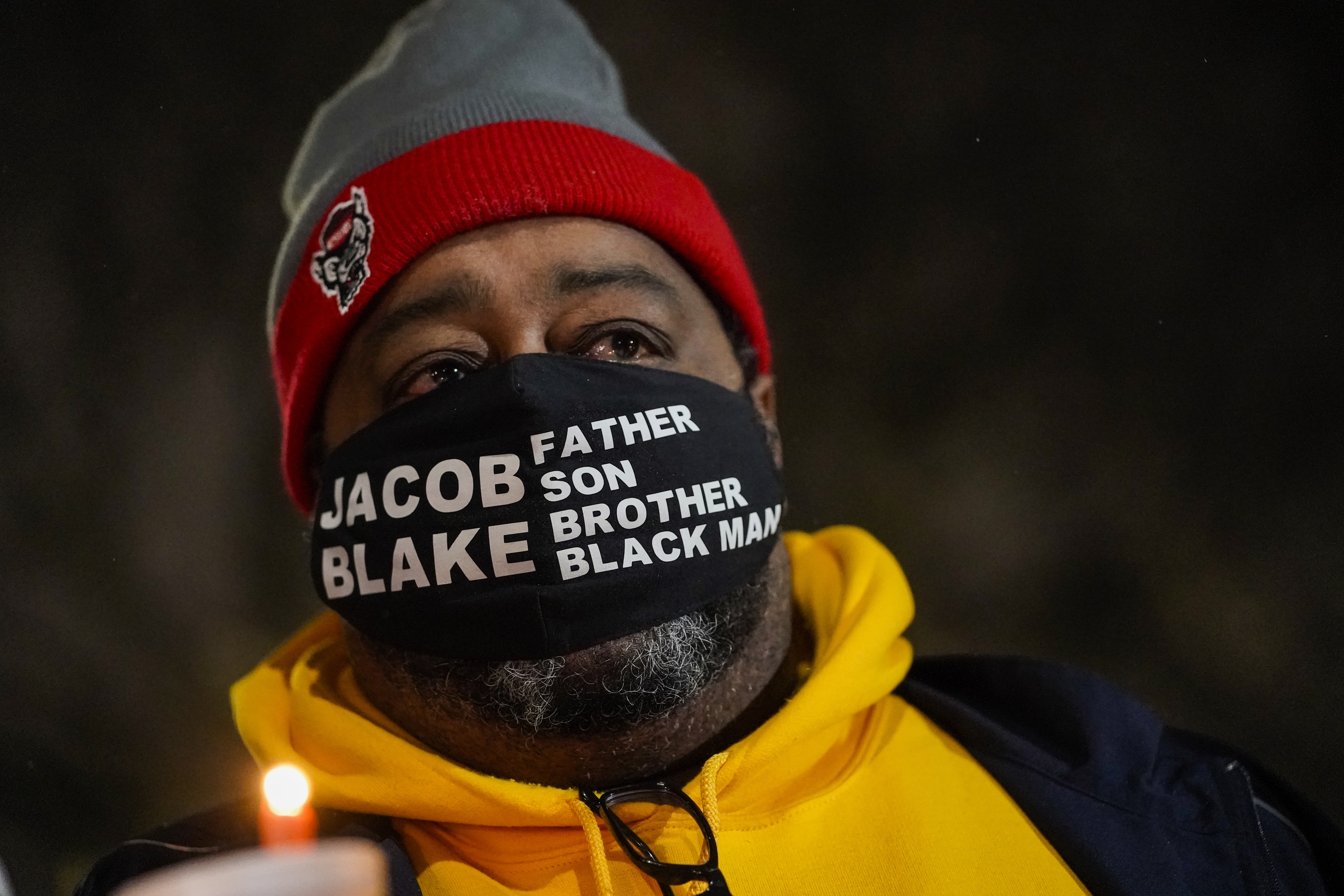 Jacob Blake Sr., father of Jacob Blake, holds a candle at a rally Monday, Jan. 4, 2021, in Kenosha, Wis.