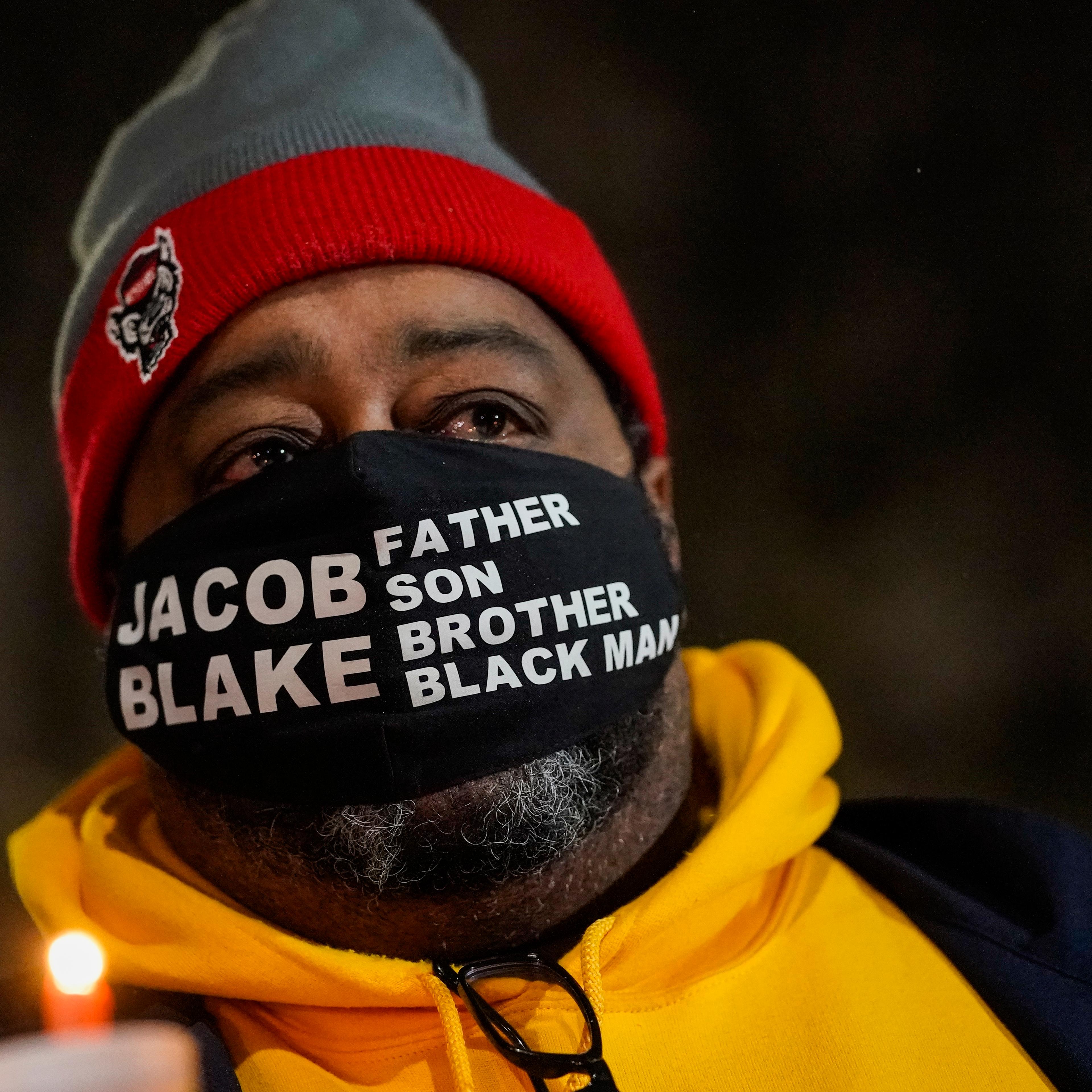 Jacob Blake Sr., father of Jacob Blake, holds a candle at a rally Monday, Jan. 4, 2021, in Kenosha, Wis.