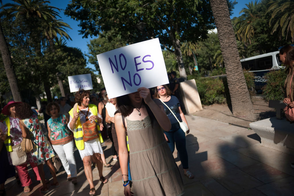 A woman holds a placard during the demonstration.Protest in