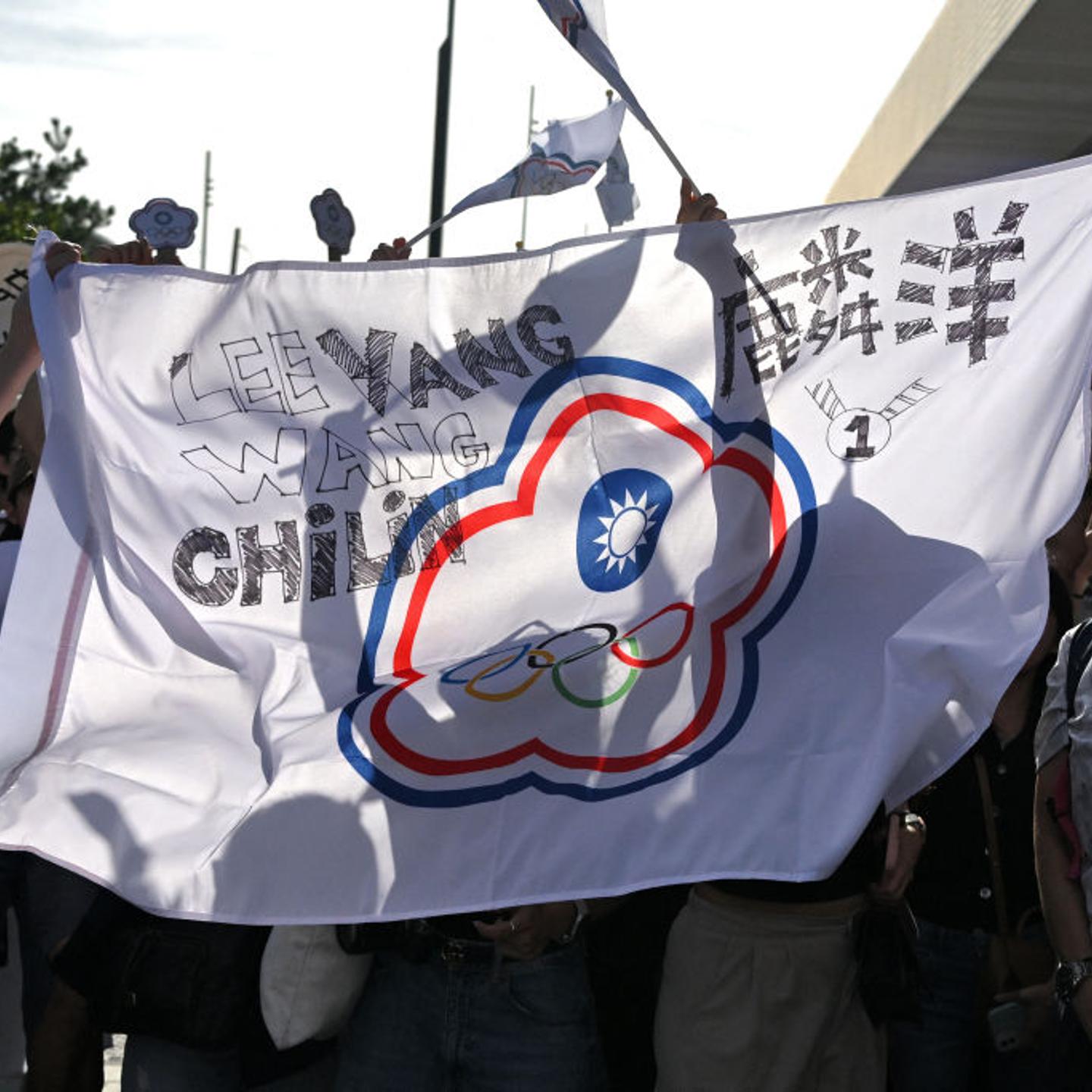 Supporters of Taiwan's Lee Yang and Wang Chi-lin celebrate with the Chinese Taipei Olympic flag outside the Porte de la Chapelle Arena in Paris on Aug. 4, 2024, after they won the gold medals in men's doubles badminton during the Paris 2024 Olympic Games