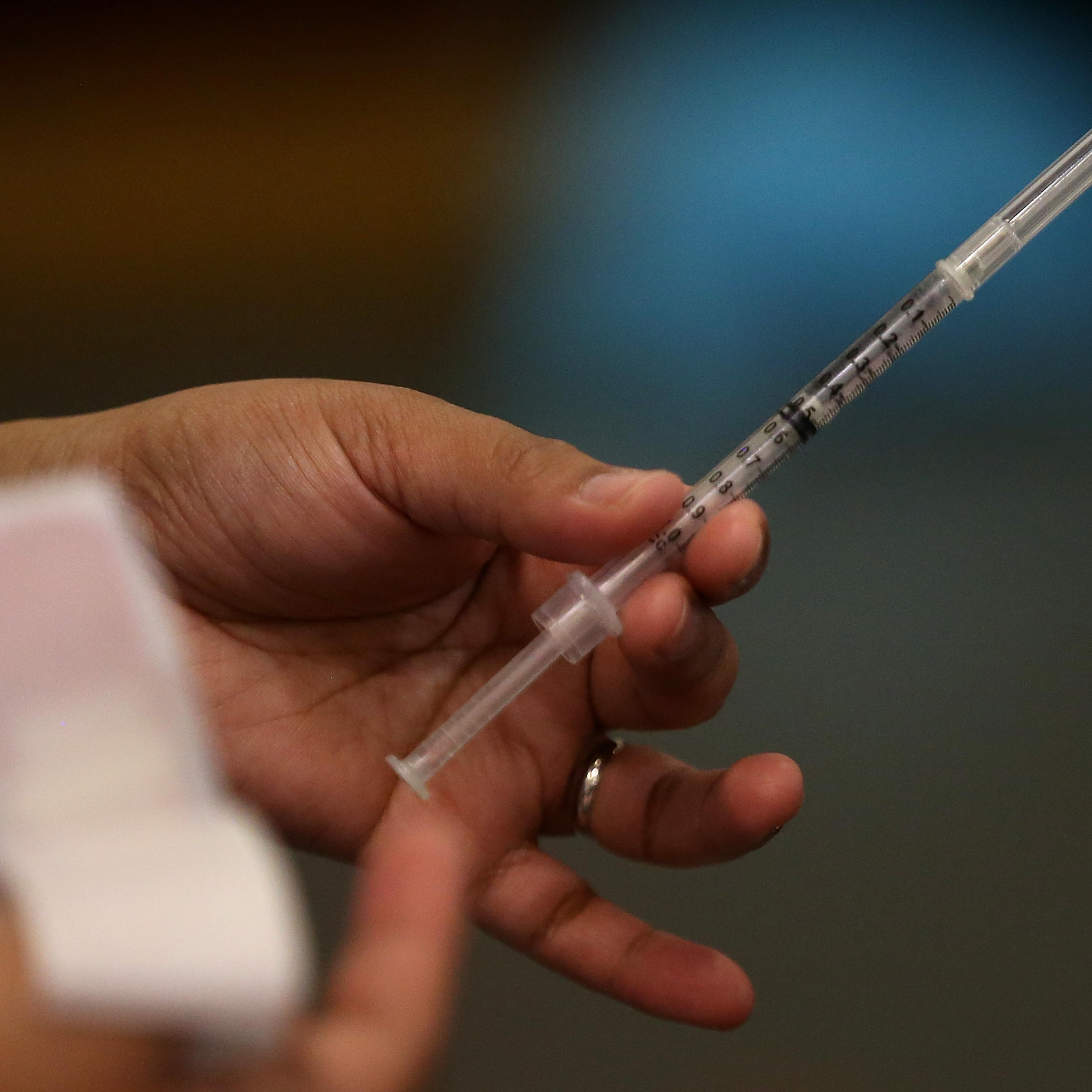A Walgreens employee holds a flu shot clinic on Dec. 19, 2014 in Oakland, California.