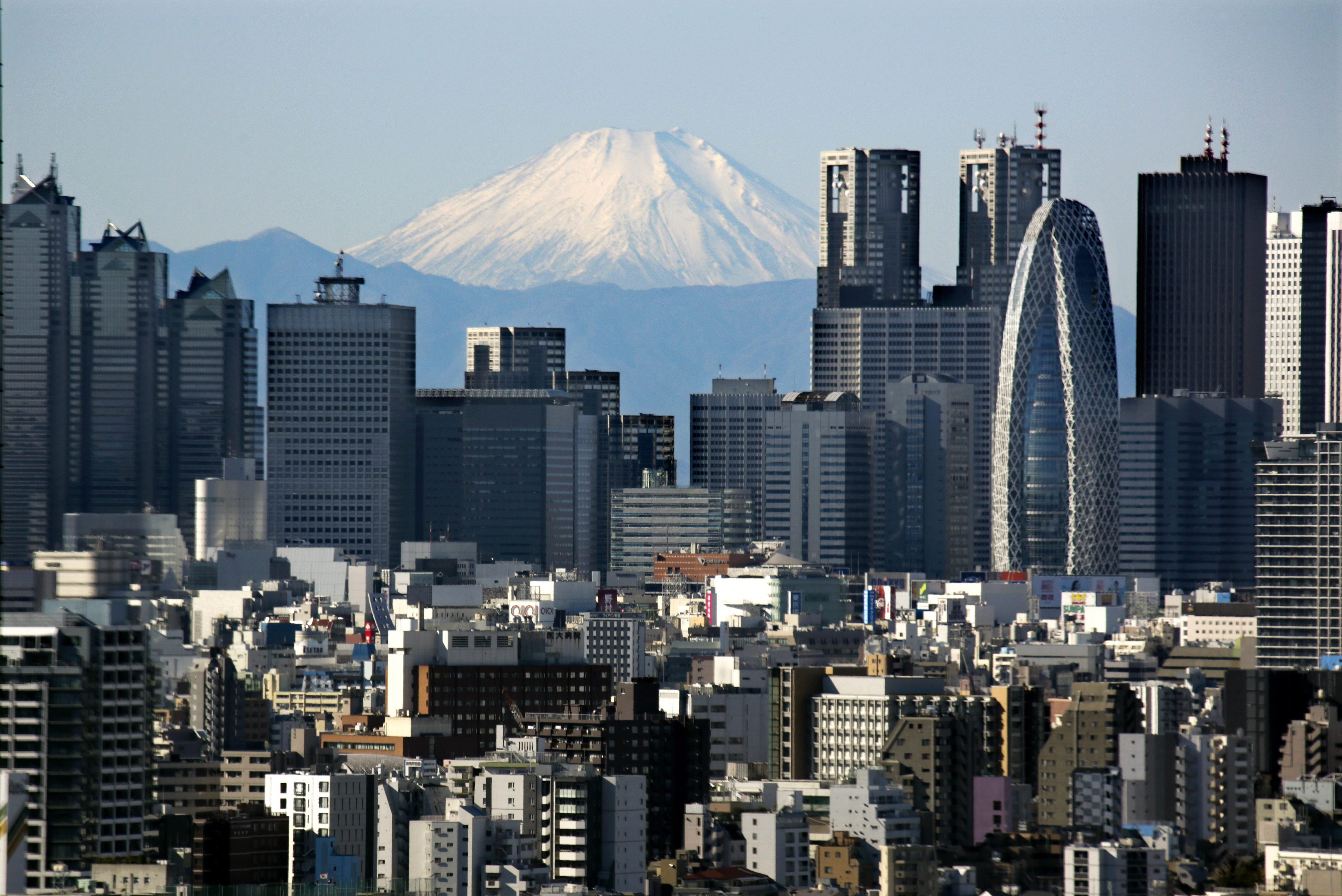 Japan's highest peak of Mt. Fuji and Shinjuku skyscrapers in central Tokyo, on Dec. 16, 2013.