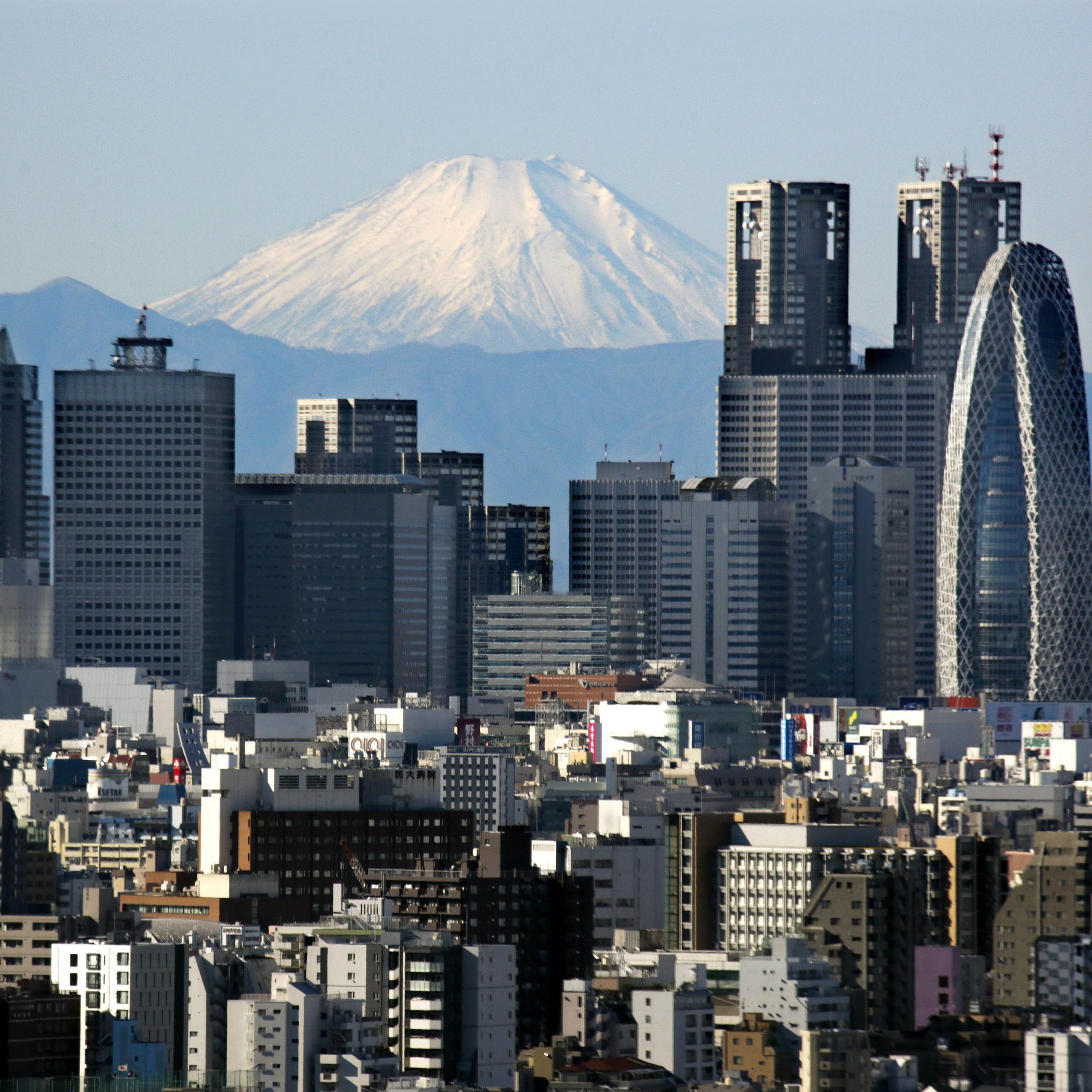 Japan's highest peak of Mt. Fuji and Shinjuku skyscrapers in central Tokyo, on Dec. 16, 2013.