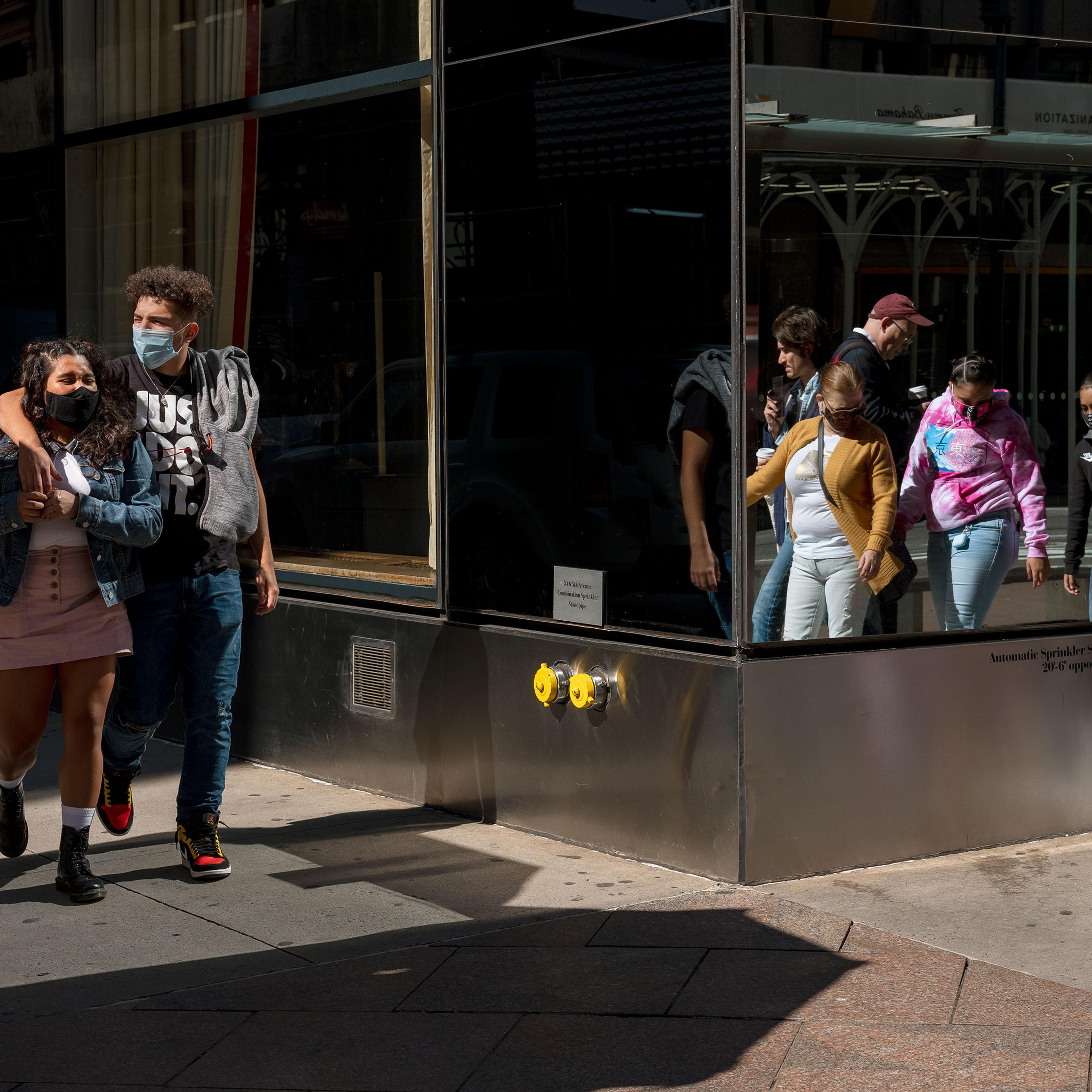 People wearing masks walk in Midtown Manhattan, at 45th st, and 5th ave on Oct. 3, 2020.