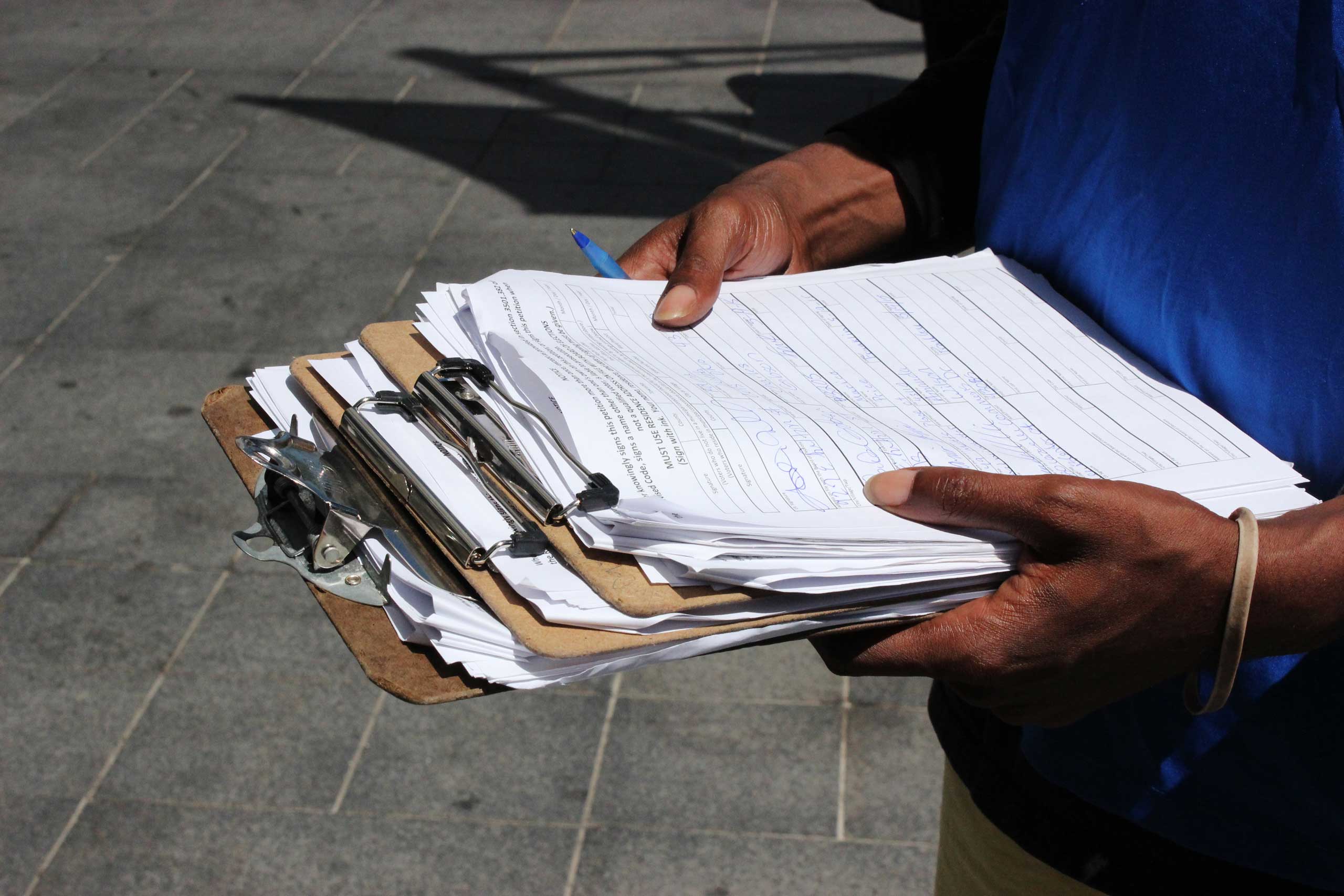 Hundreds of thousands of signatures are being collected to put a measure on the November ballot to legalize recreational and medical marijuana in Ohio and give only 10 companies the right to grow the drug wholesale. Here professional signature gatherer D