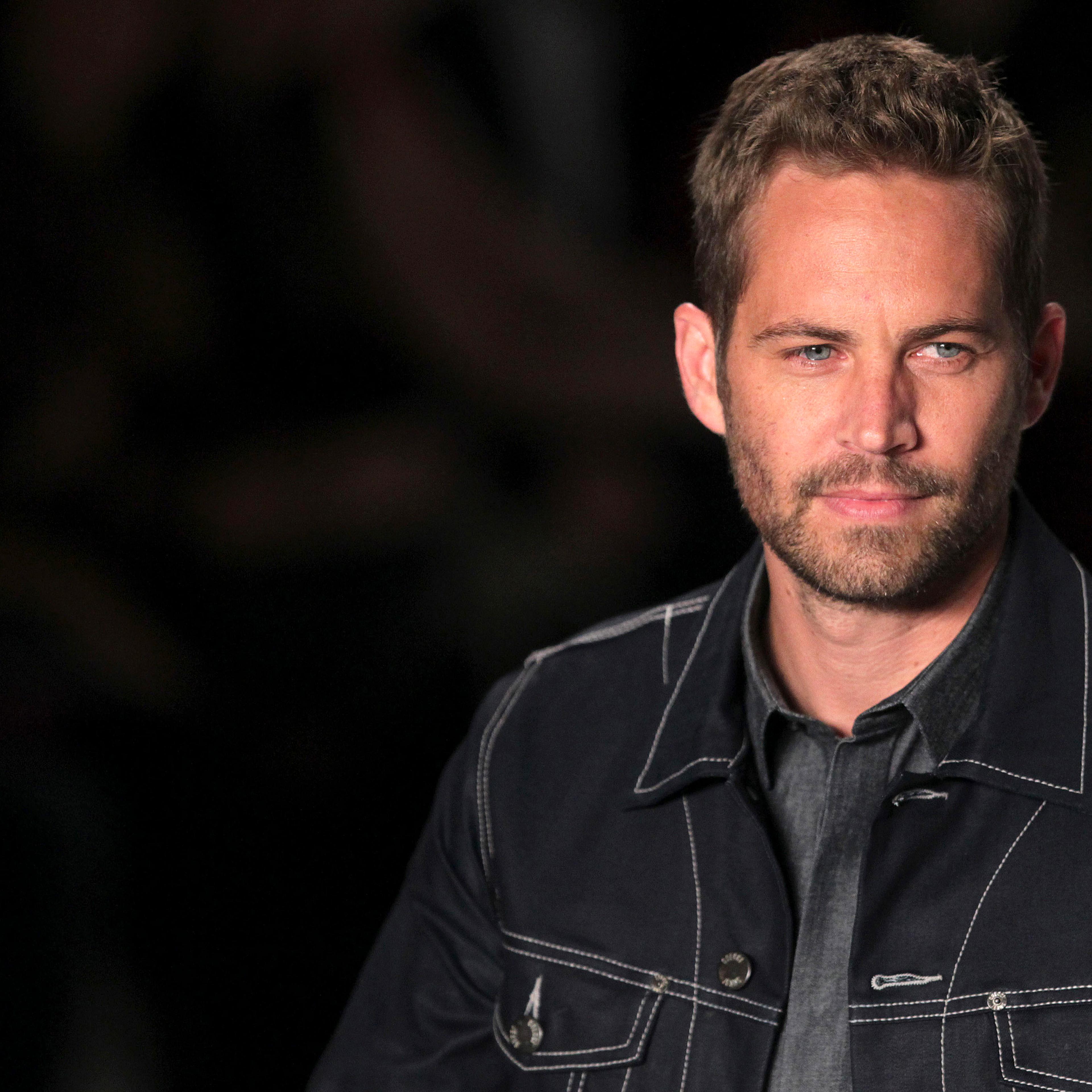 U.S. actor Walker presents a creation from Colcci's 2013/2014 summer collection during Sao Paulo