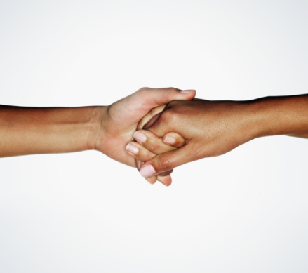 Two young women linking hands