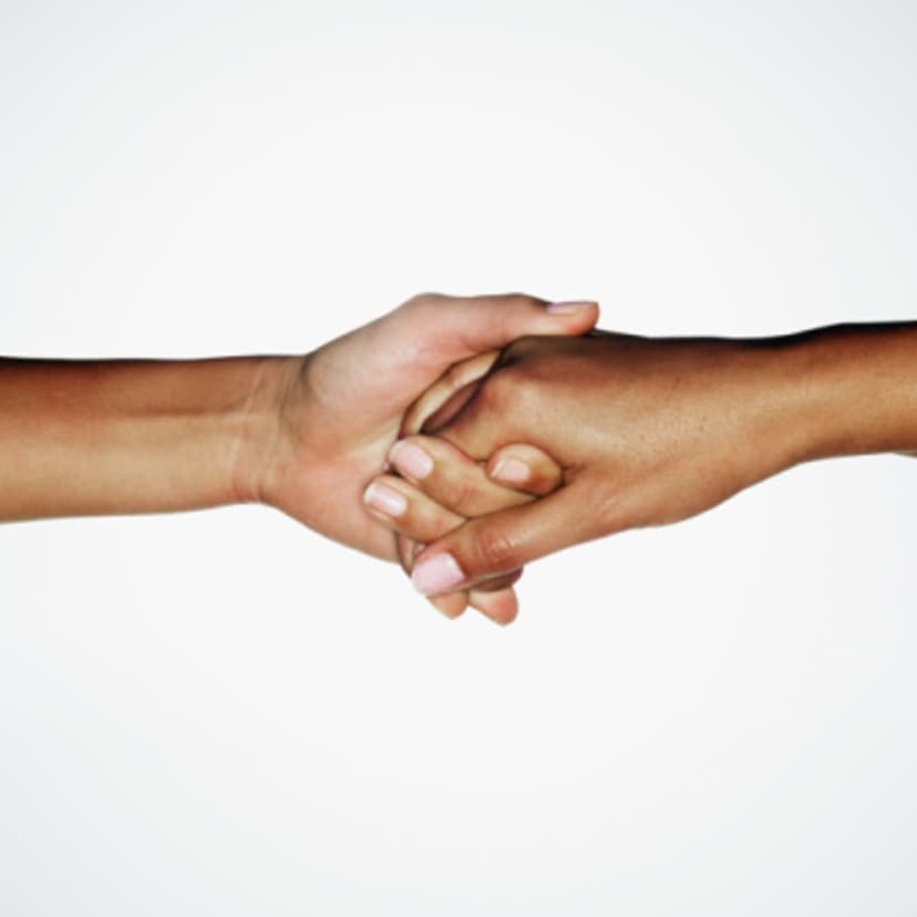 Two young women linking hands