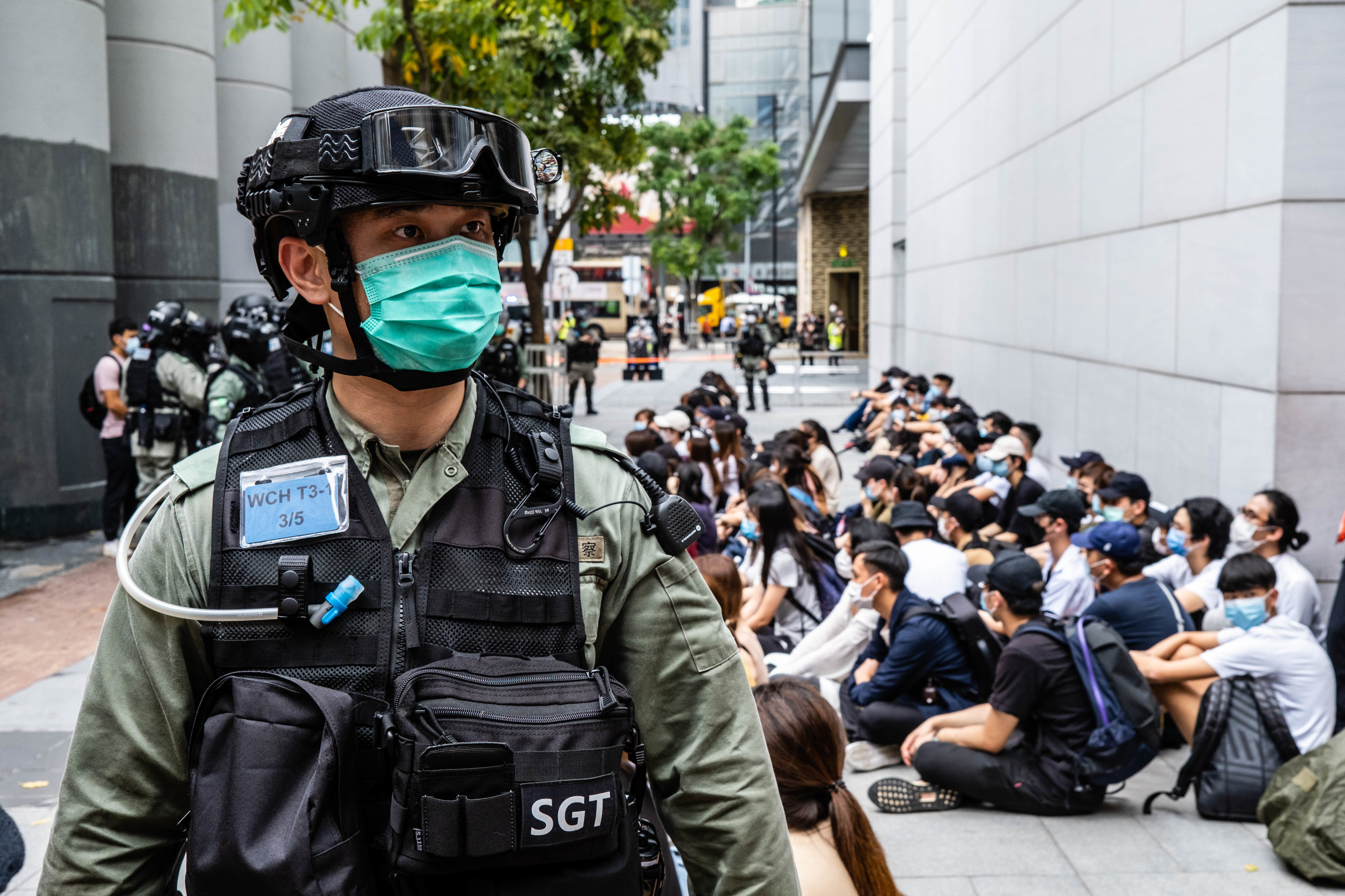 Riot police round up a group of protesters during the
