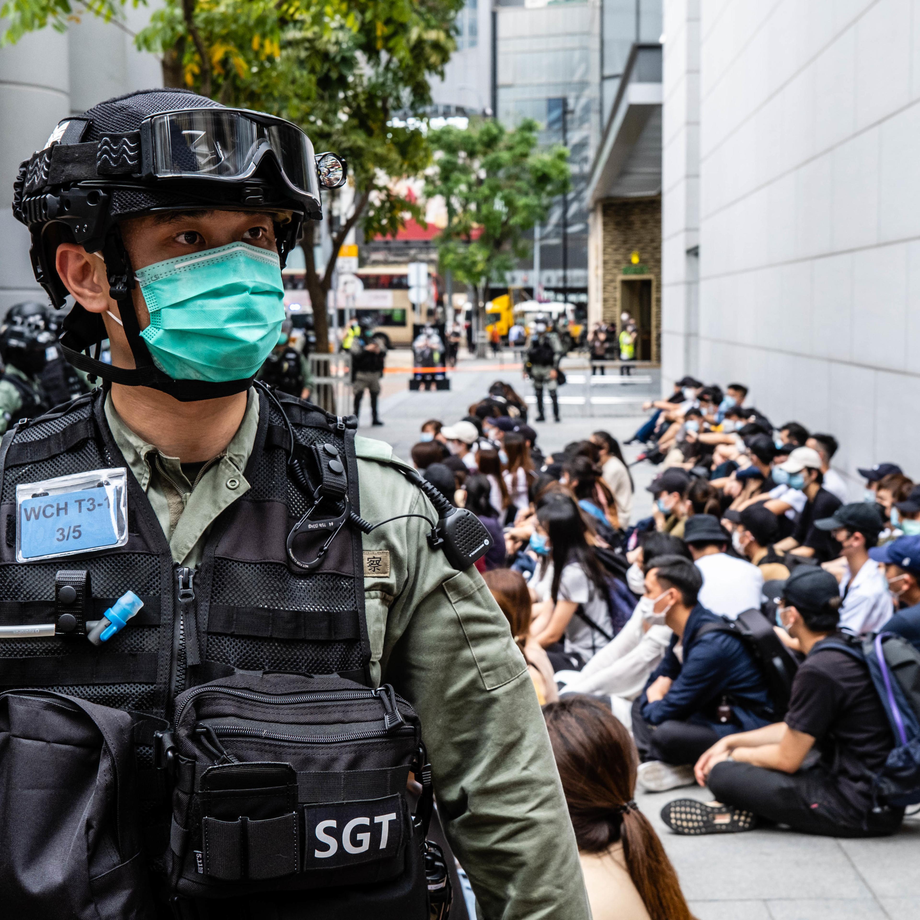 Riot police round up a group of protesters during the