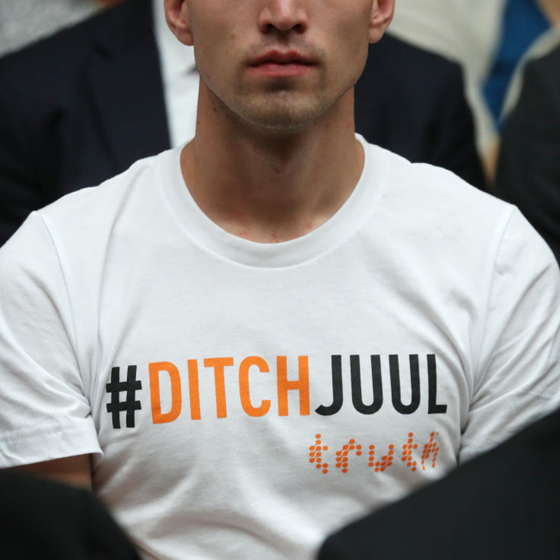 A young man wears a #DitchJuul shirt during a Congressional hearing
