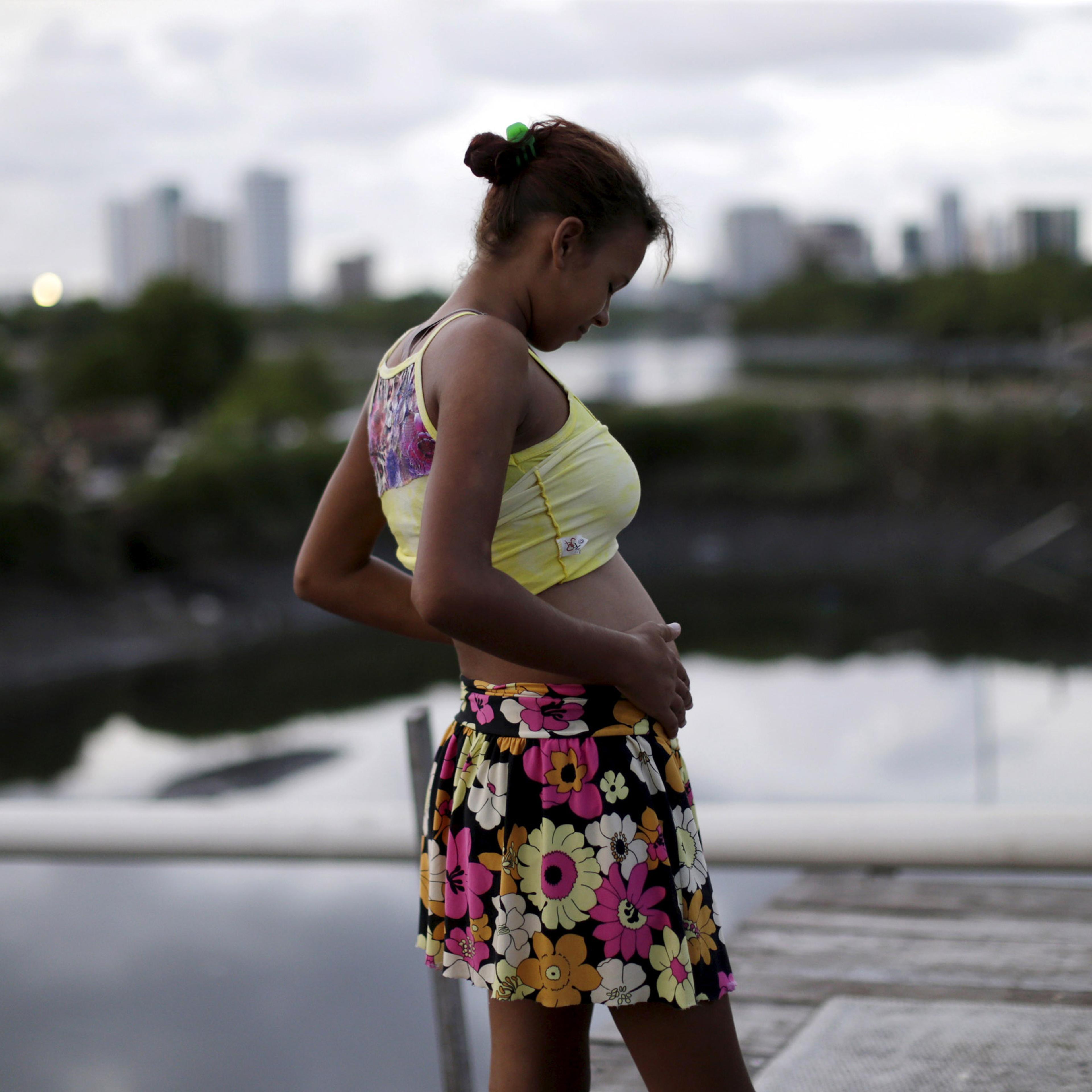 Eritania Maria, who is six months pregnant, is seen in front of her house at a slum in Recife