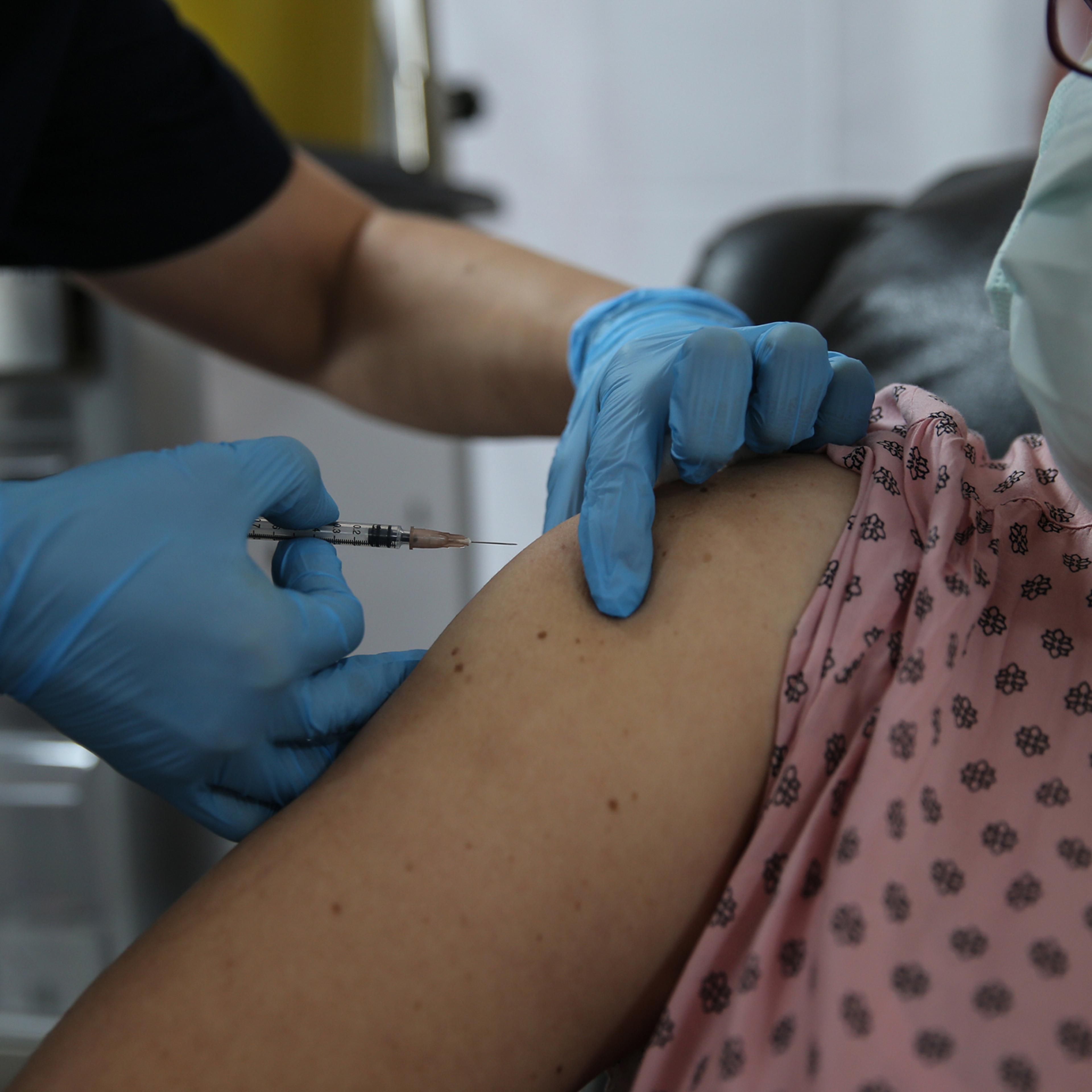 A volunteer gets a shot on Oct. 27 in the Phase 3 study of Pfizer’s vaccine candidate