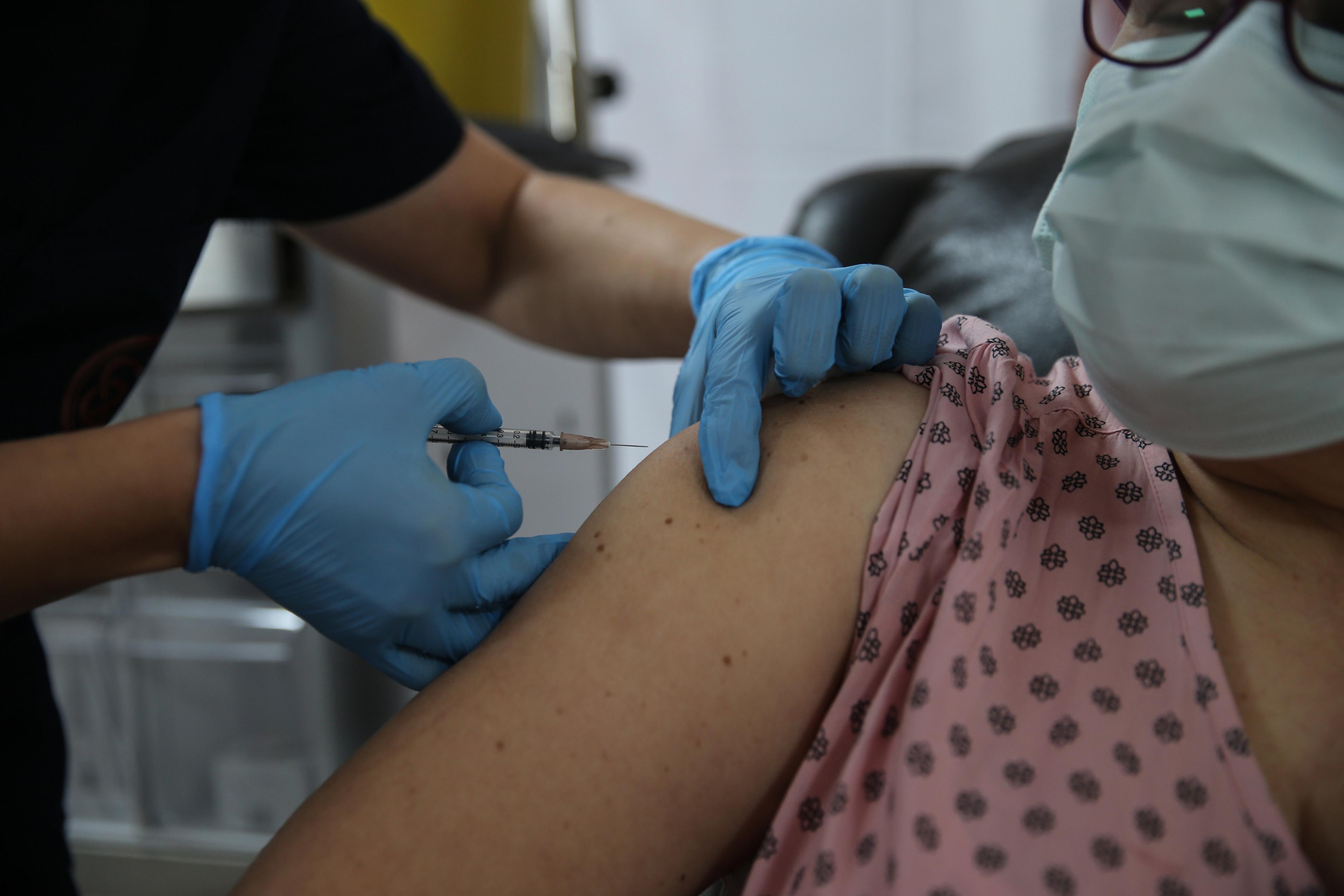 A volunteer gets a shot on Oct. 27 in the Phase 3 study of Pfizer’s vaccine candidate
