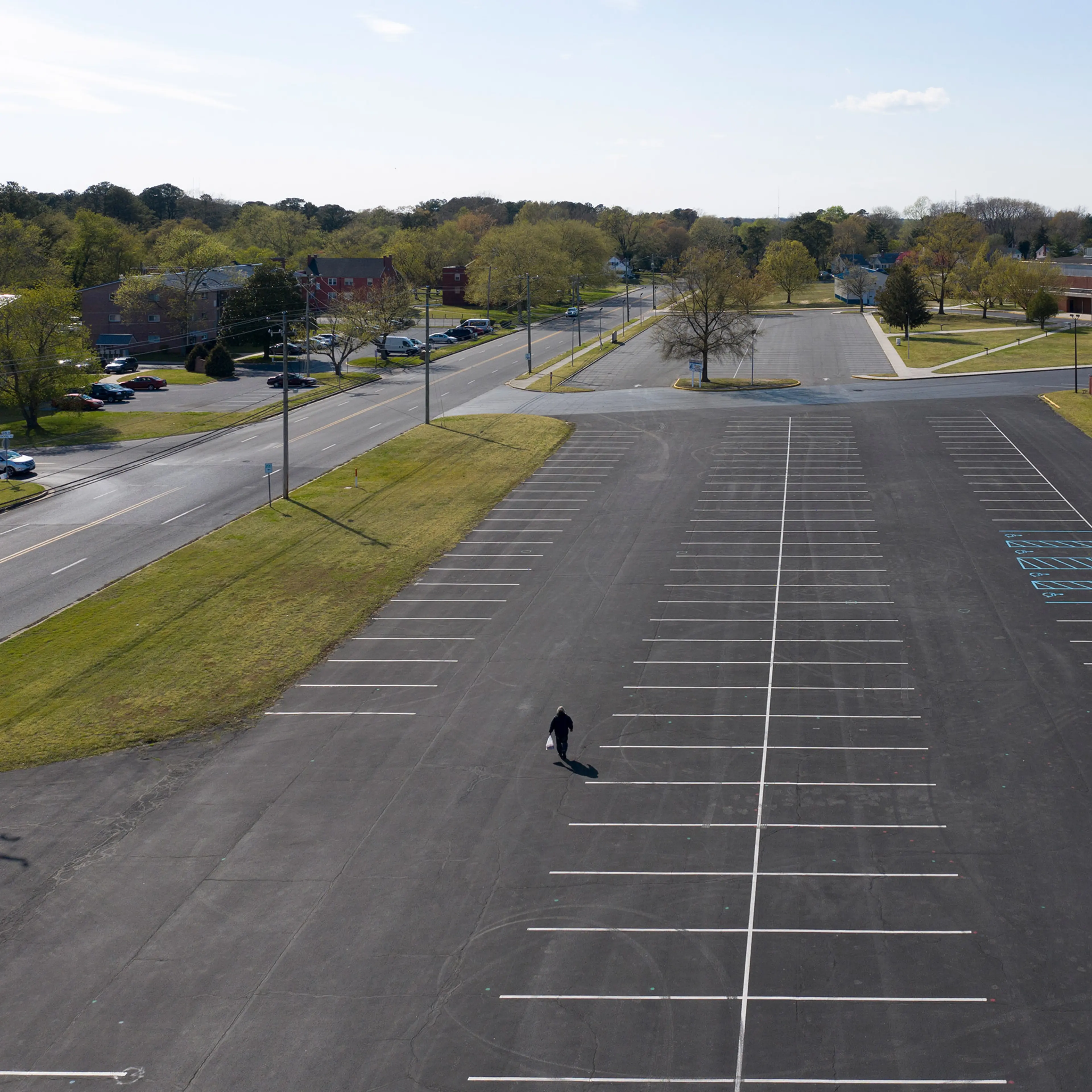 2020. USA. Salisbury, Maryland. A man walks through the parking lot of the Wicomico County Stadium in Salisbury, Maryland. during the Corona virus (Covid 19).