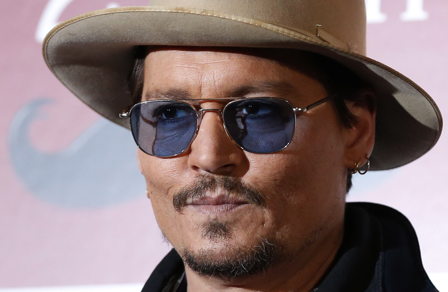 Actor Johnny Depp poses during a photo session ahead of a news conference for his movie "Mortdecai" in Tokyo January 28, 2015.