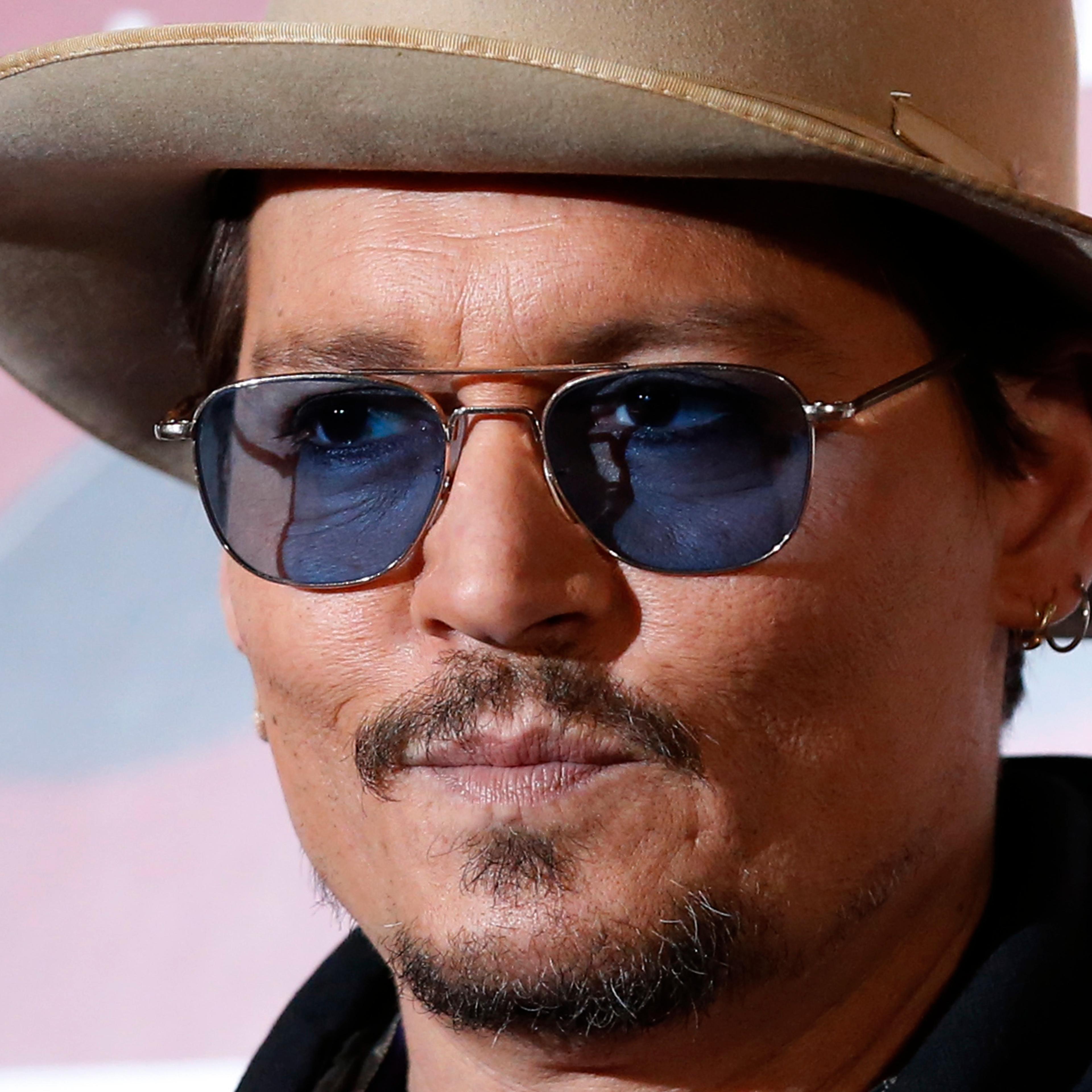 Actor Johnny Depp poses during a photo session ahead of a news conference for his movie "Mortdecai" in Tokyo January 28, 2015.