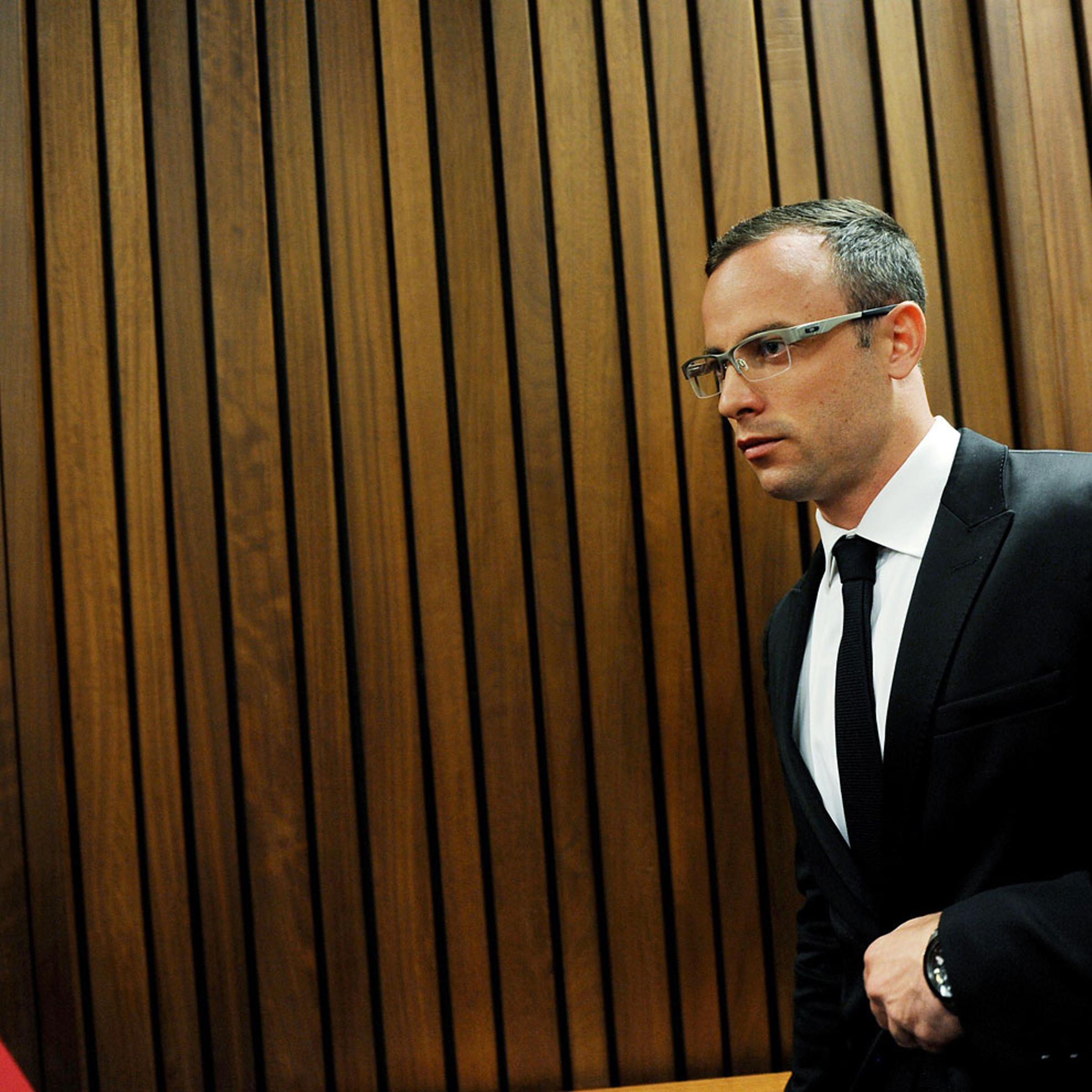 Paralympian Oscar Pistorius exits the courtroom after his murder trial was postponed at the high court in Pretoria on March 28, 2014.